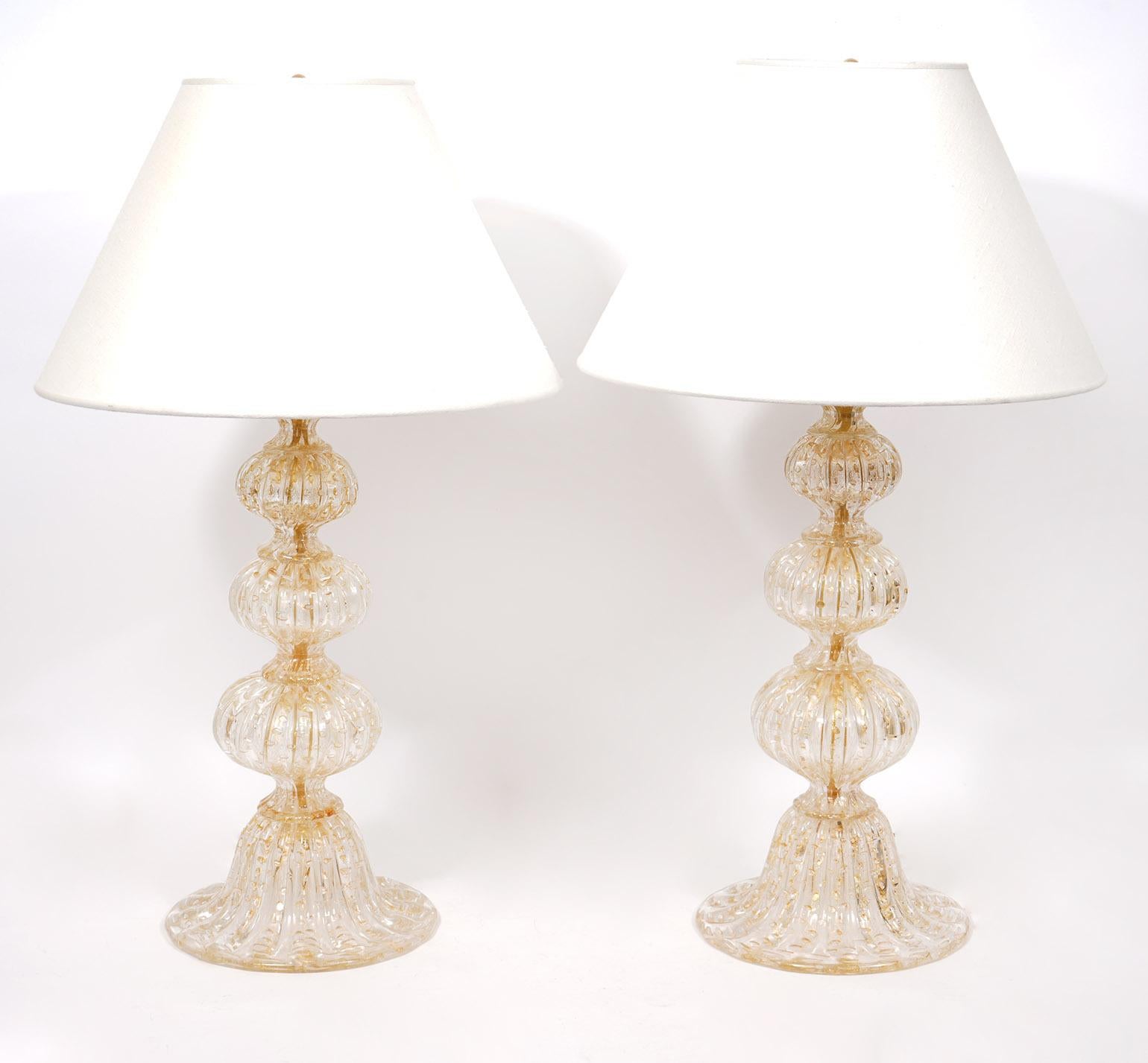 Pair of Mid-Century Modern Italian Murano table lamps. Ball form with gold fleck. Shades are free if you add $75 for shipping. Otherwise we are selling the lamps without shades to help for shipping. 30