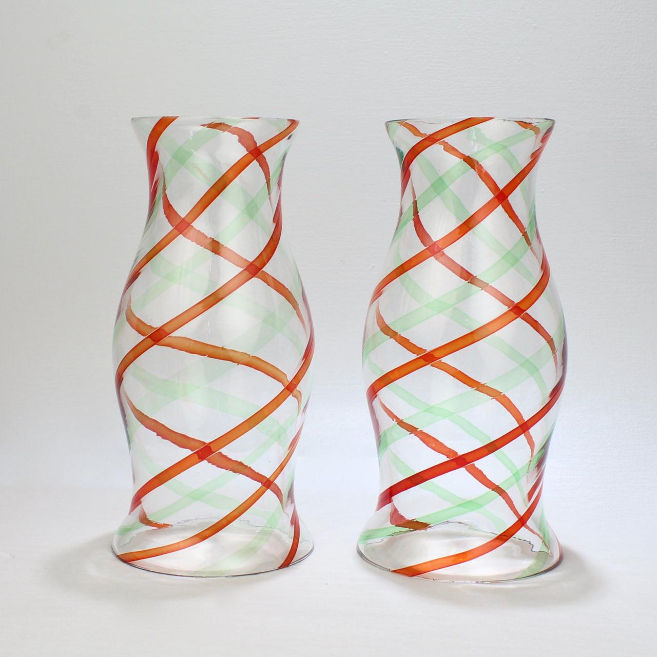 A pair of fine Italian art glass hurricane shades for candlesticks.

With 'fasce ritorte' twisted ribbon decoration in green and red on a clear ground. 

In the style of Fulvio Bianconi and Venini.

Simply a great pair of Venetian hurricane