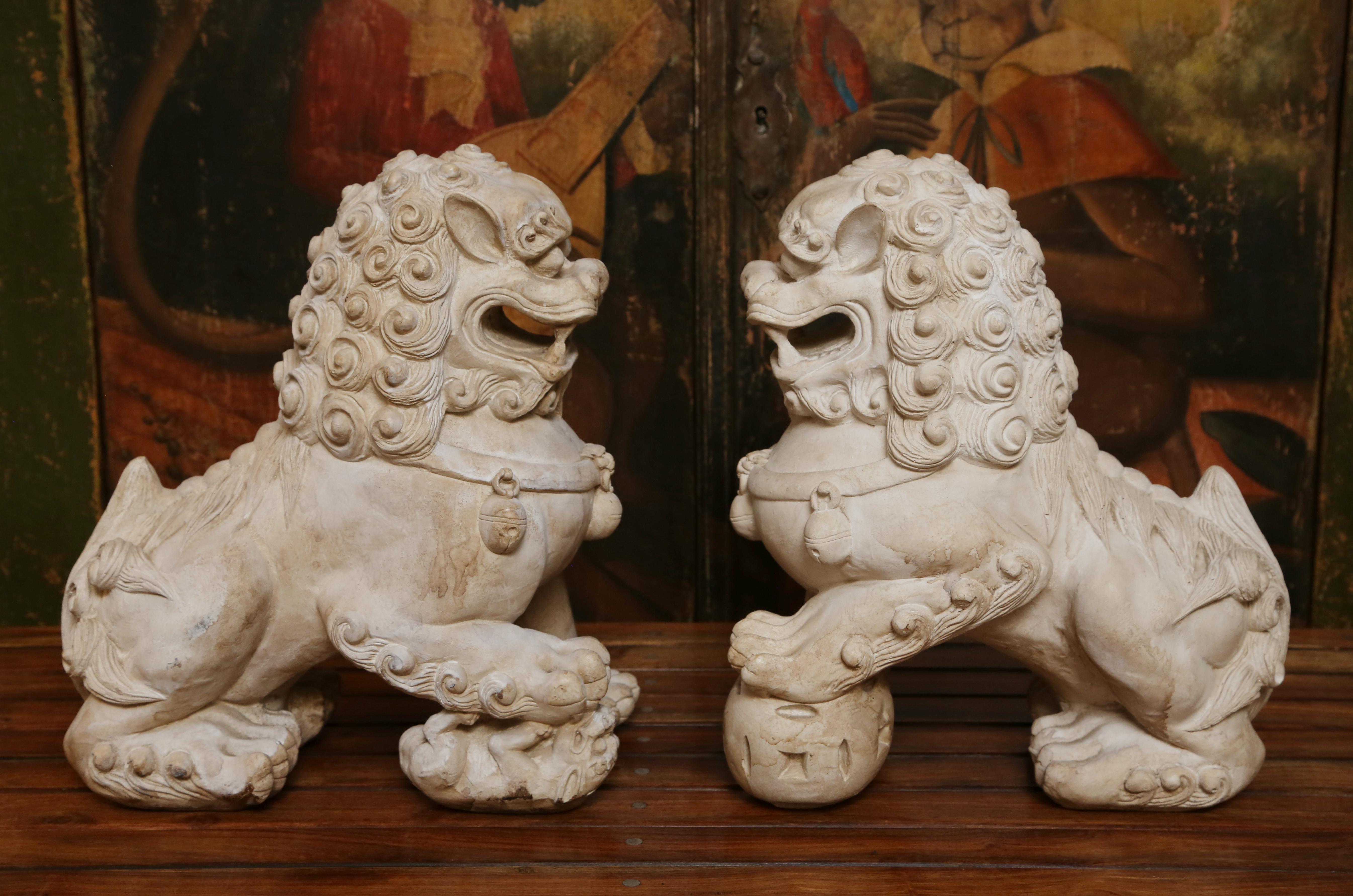 Beautifully detailed pair of natural bisque foo dogs.