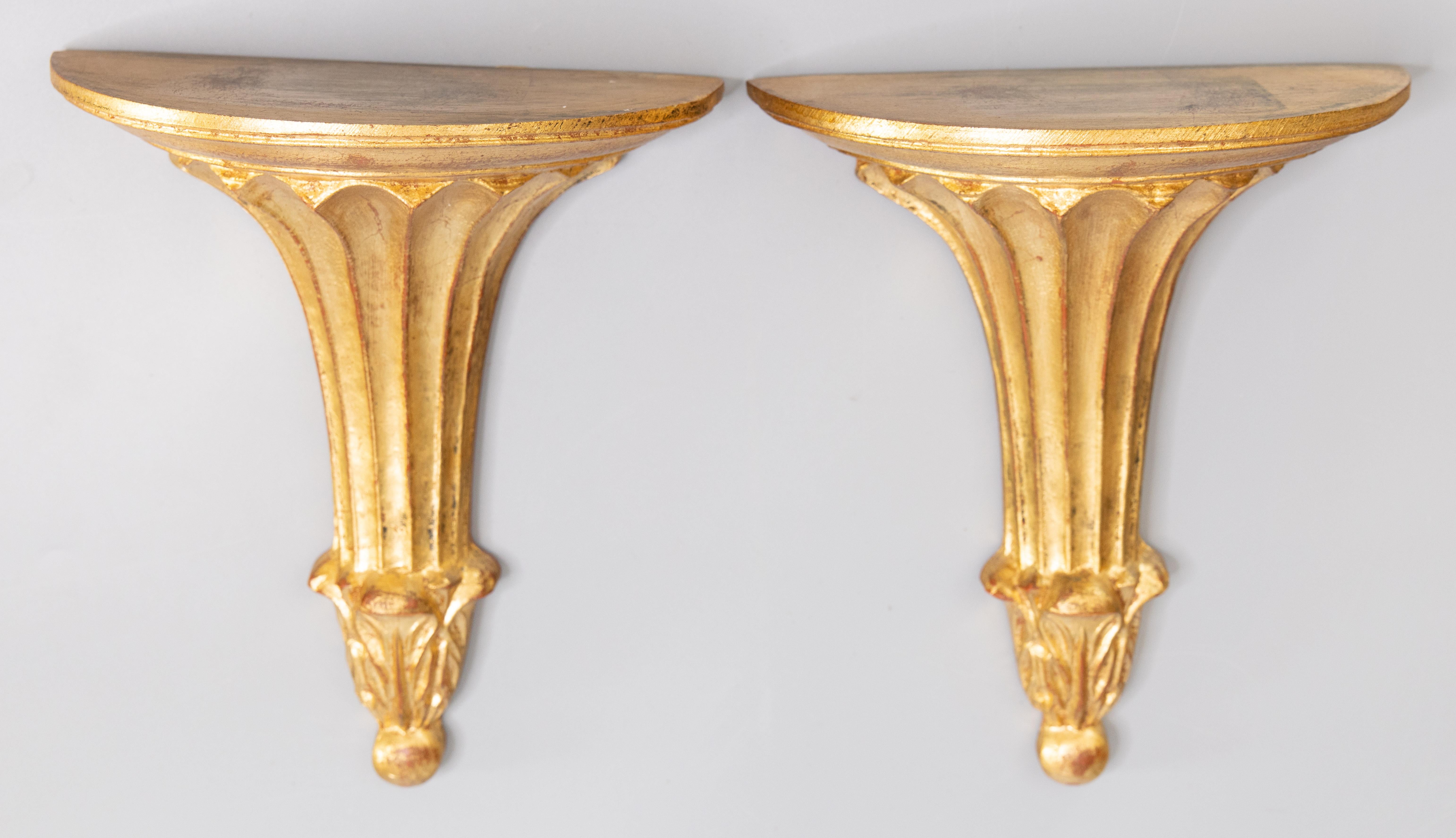 A stunning pair of vintage midcentury Neoclassical style Italian Florentine gilded wood wall brackets or shelves. Florentia label and impressed maker's mark 