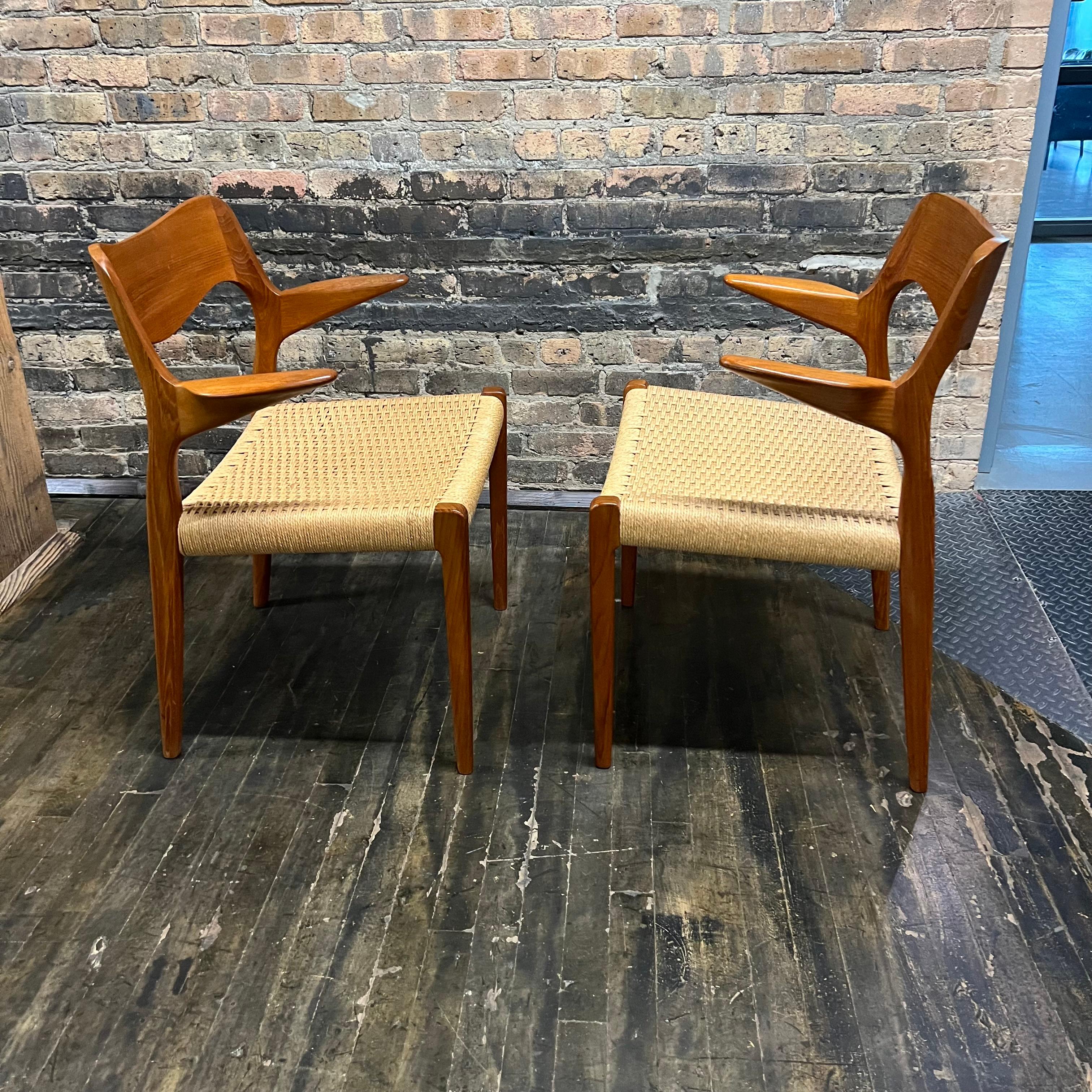This beautiful pair of iconic Niels Møller captain's chairs in teak have Danish cord seats and beautifully sculpted teak arms that appear to float off the central frame.  The chairs are in near perfect original condition.  They were clearly rarely