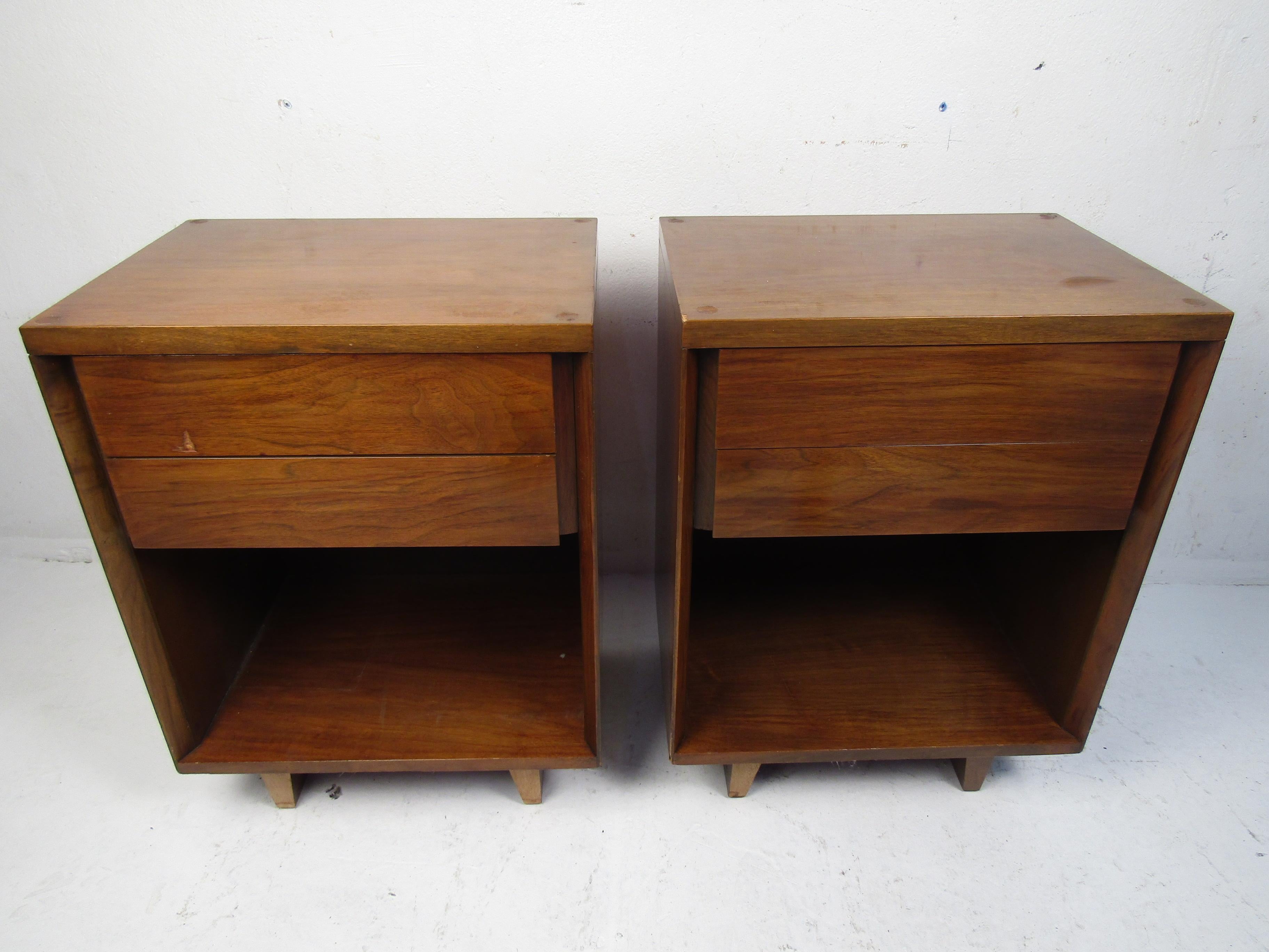 Stylish midcentury nightstands sold by John Stuart. Two dovetail jointed drawers on each, with open storage space beneath. Please confirm item location with dealer (NJ or NY).