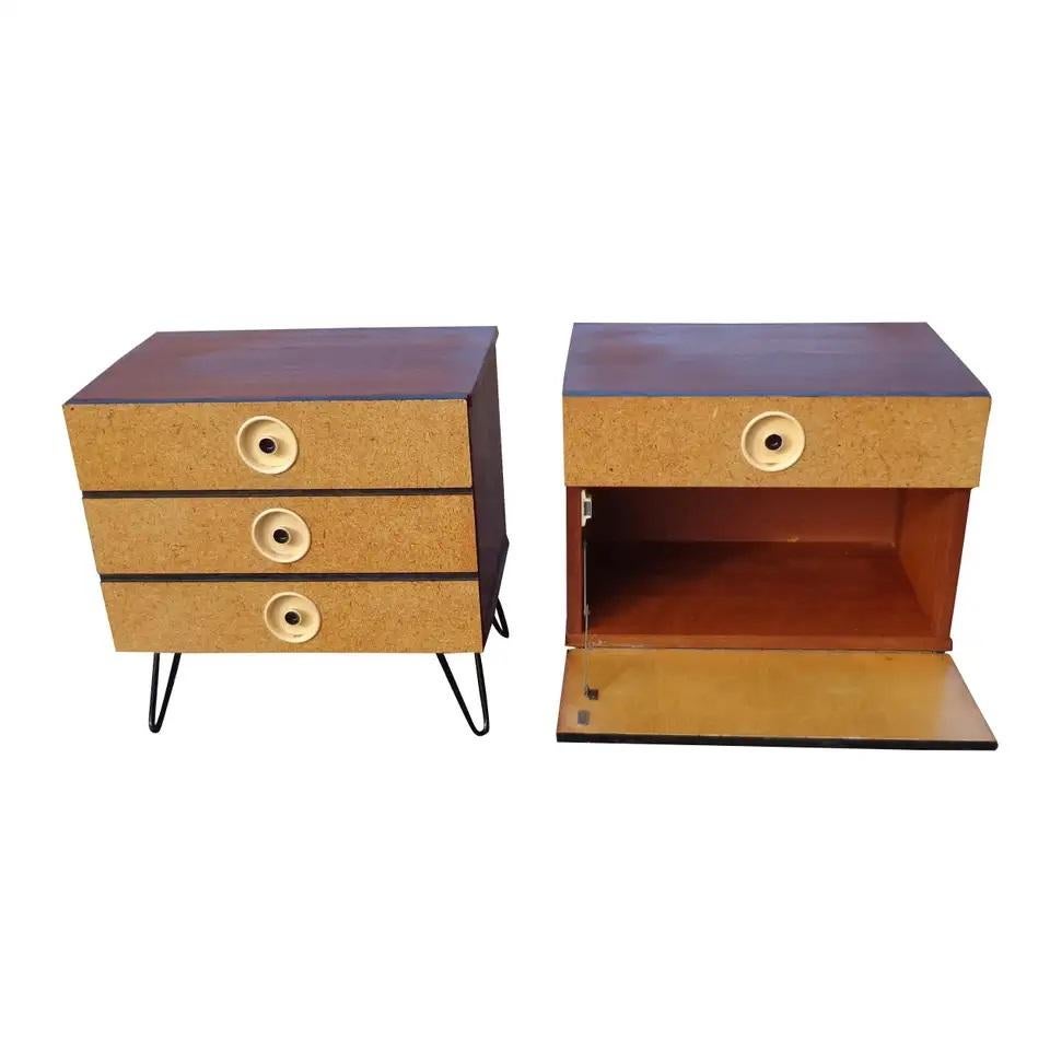 Pair of mid century nightstands featuring cork fronts

Pair of walnut vintage nightstands or side tables with metal hairpin legs in the style of Paul Frankl. Featuring circular recessed bakelite pulls and cork facings. One with three drawers and