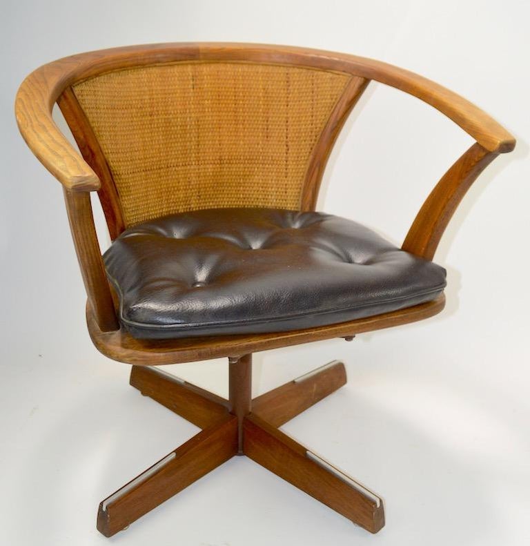 Pair of Mid Century Oak and Cane Swivel Chairs at 1stDibs