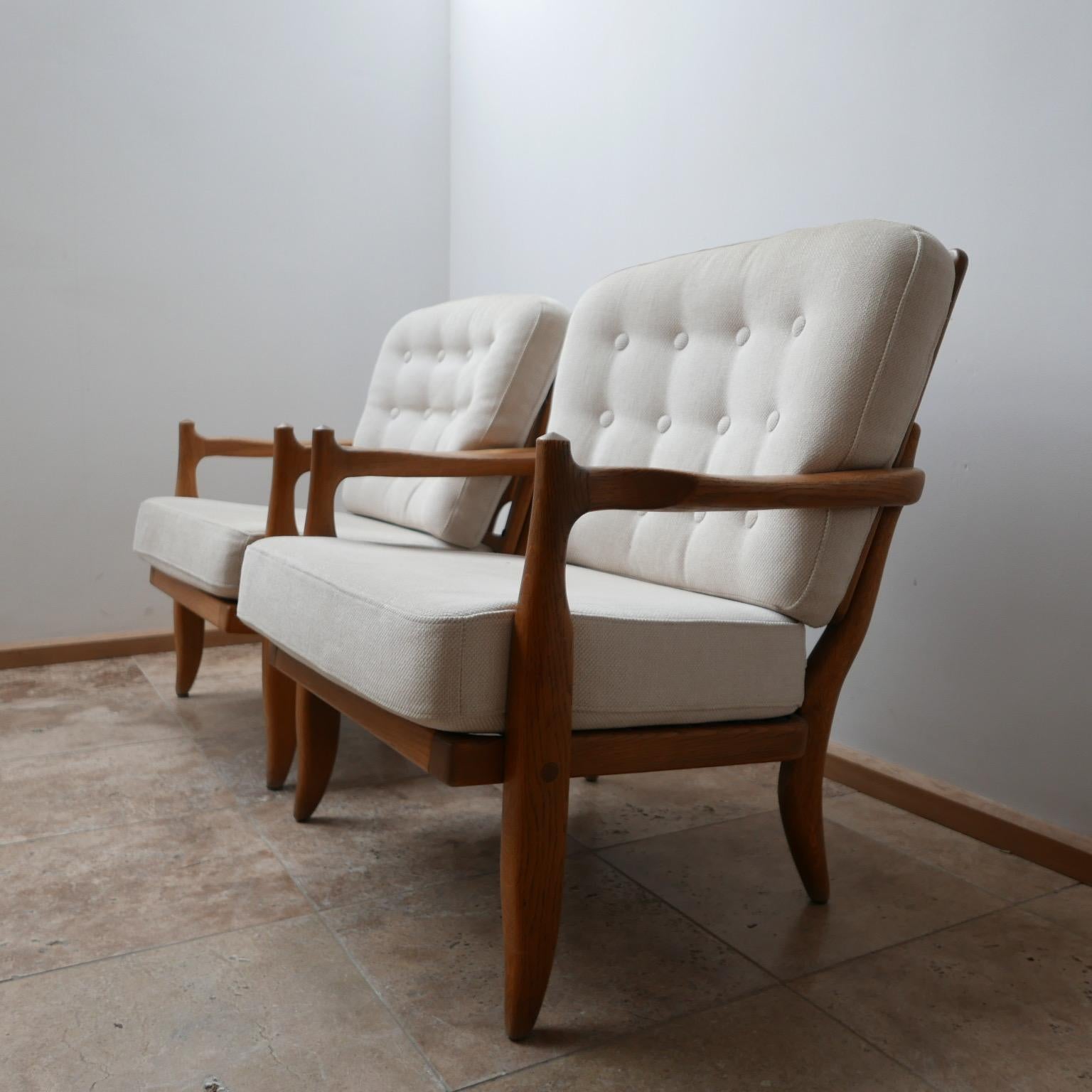 A pair of midcentury armchairs by French design legends Guillerme et Chambron. 

French, circa 1960s.

Solid oak. Original upholstery which could be cleaned and is very usable but could be updated. 

A good compact pair of armchairs that