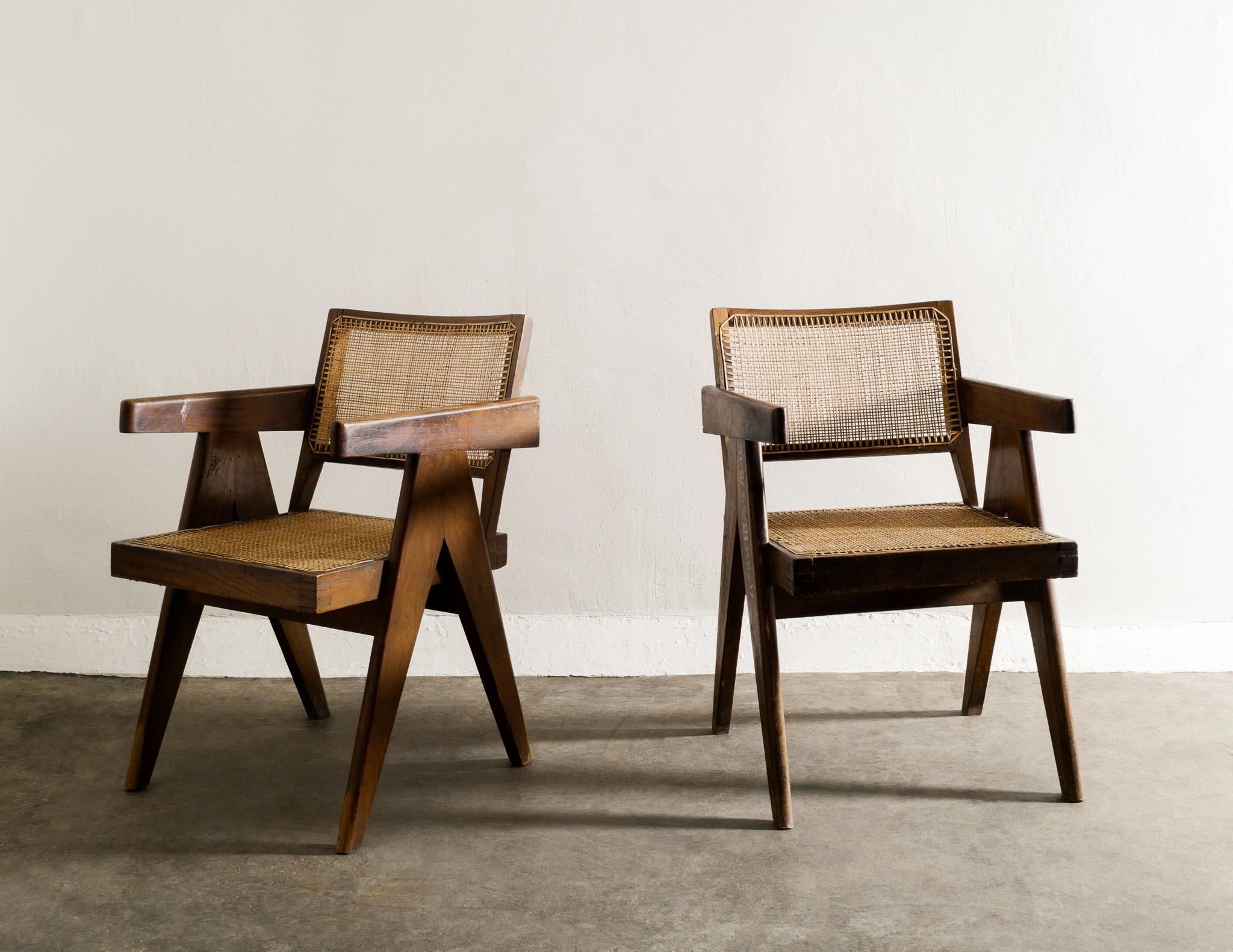 Very rare pair matching of mid century office / dining chairs by Pierre Jeanneret in teak and rattan. Great condition and patina with nice letterings. 
Produced for the Chandigarh project in India during the 1950s. 

Dimensions: H: 79 cm / 31.1