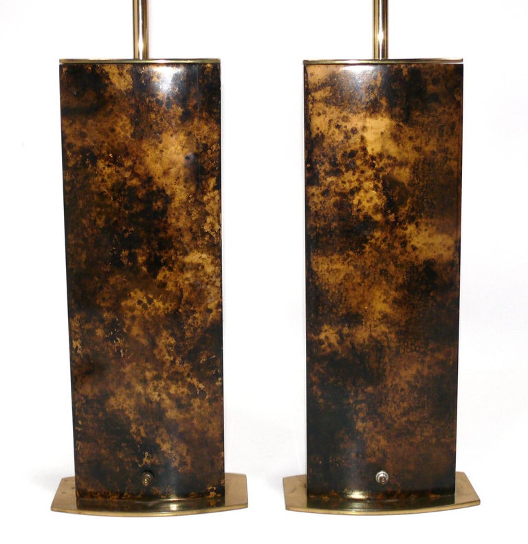 Pair of mid century oil spot finish lamps, made by The Laurel Lamp Company, American, circa 1960s. They have a beautiful oil spot or tortoise shell finish with brass plated metal bases. They retain their warm original patina. They have been rewired