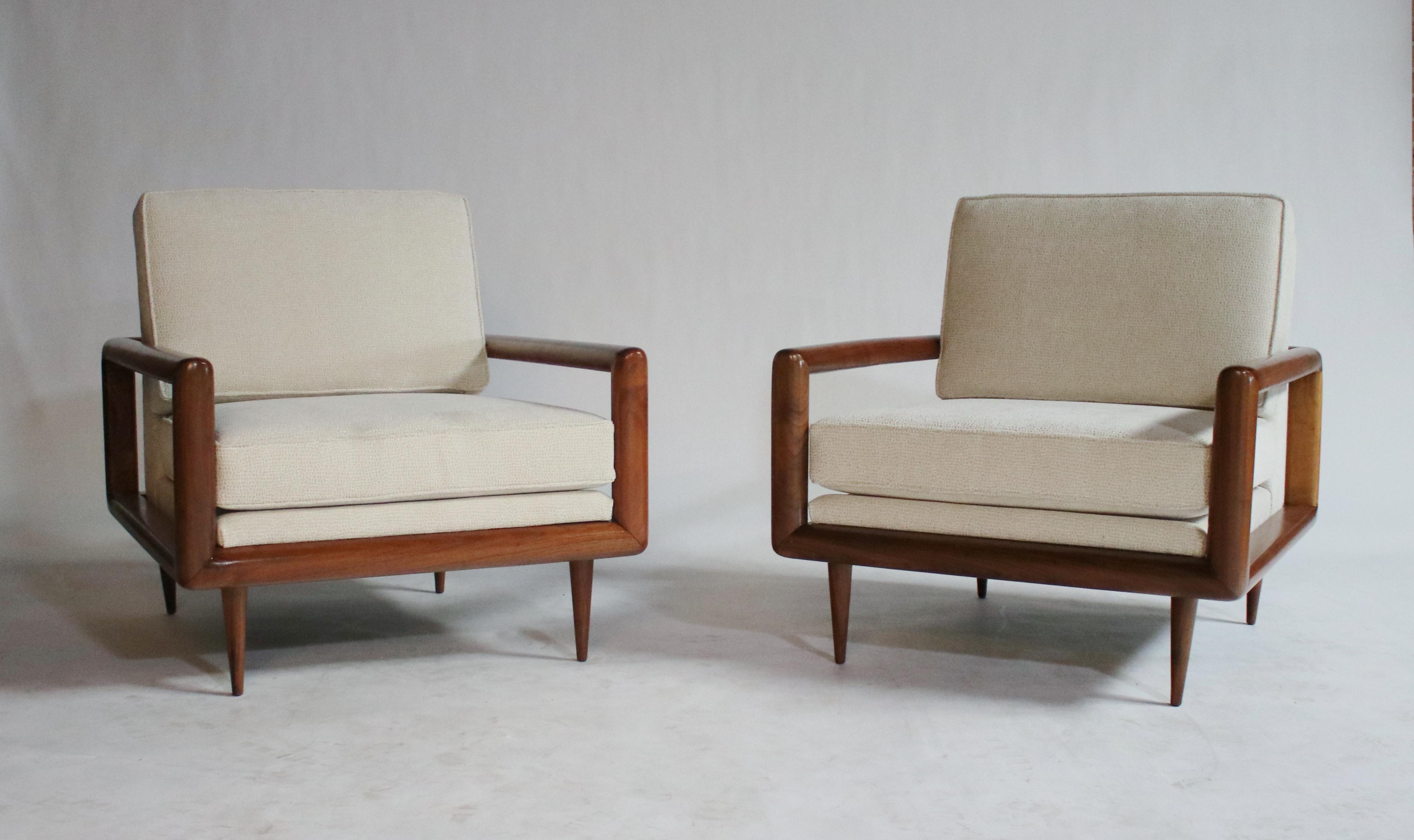 Unique and stylish modern design looks stunning from every angle, these Mid-Century Modern open arm lounge chairs are made from solid walnut frame with tapered legs and newly upholstered in designer textured fabric. In the style of T.H. Robsjohn