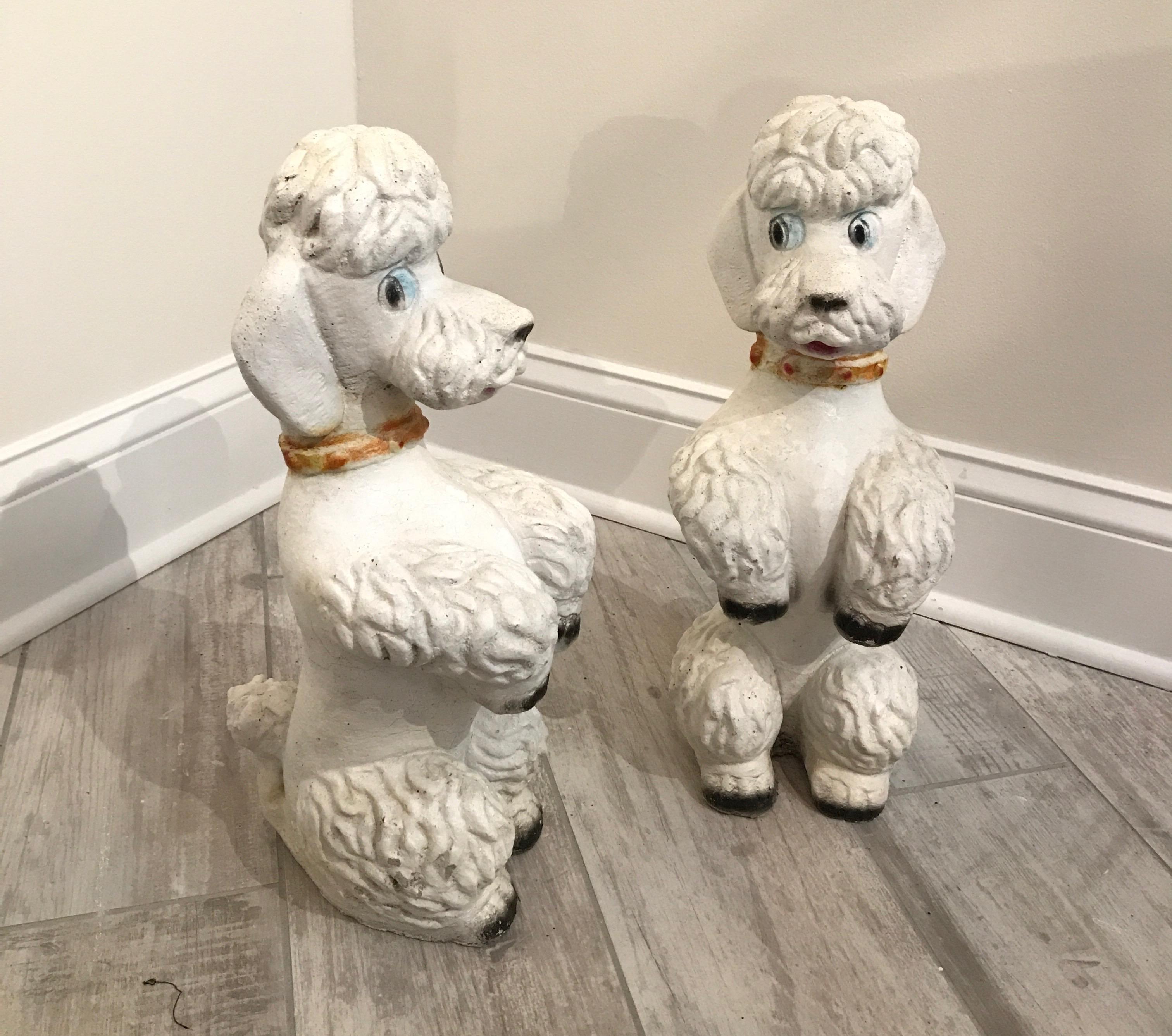 Whimsical pair of midcentury concrete standing French poodles.