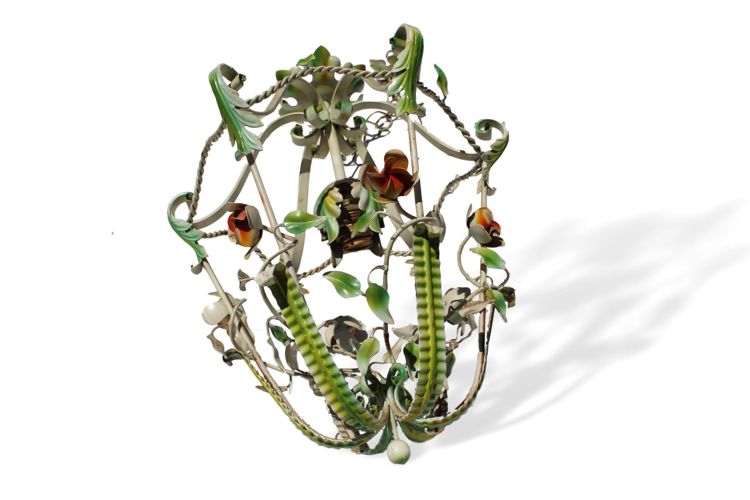 Pair of midcentury painted wrought iron hanging lantern light fixtures, Italian, each fitted with a central light, framed by vining flowers and foliates.
Measures: 15.75