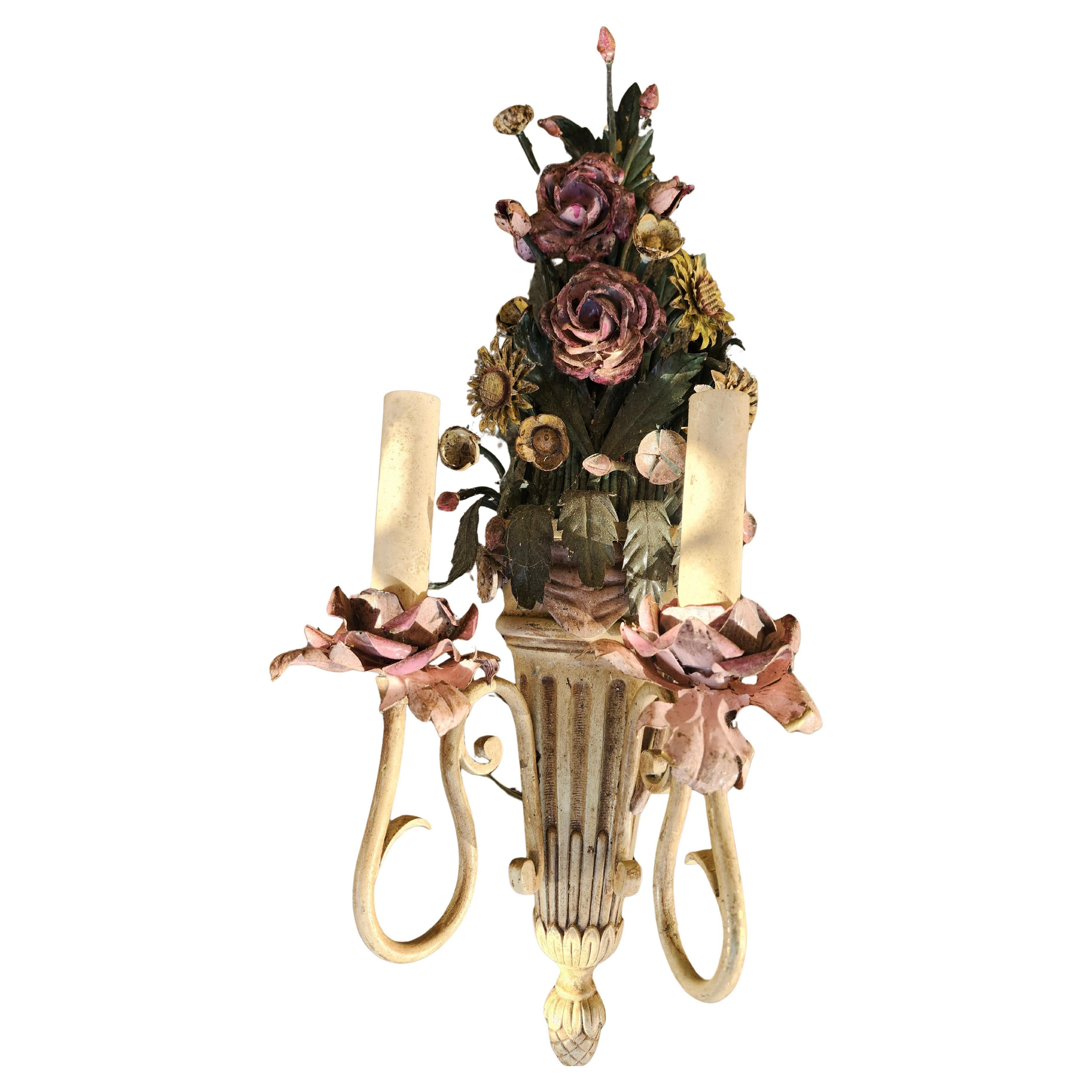Fantastic pair of detailed and well executed toleware sconces from Italy. Budding roses and other floral bouquets in a classical style urn is the theme and they are aged to perfection. Each has a double  Candlabra sized socket flanking each other.