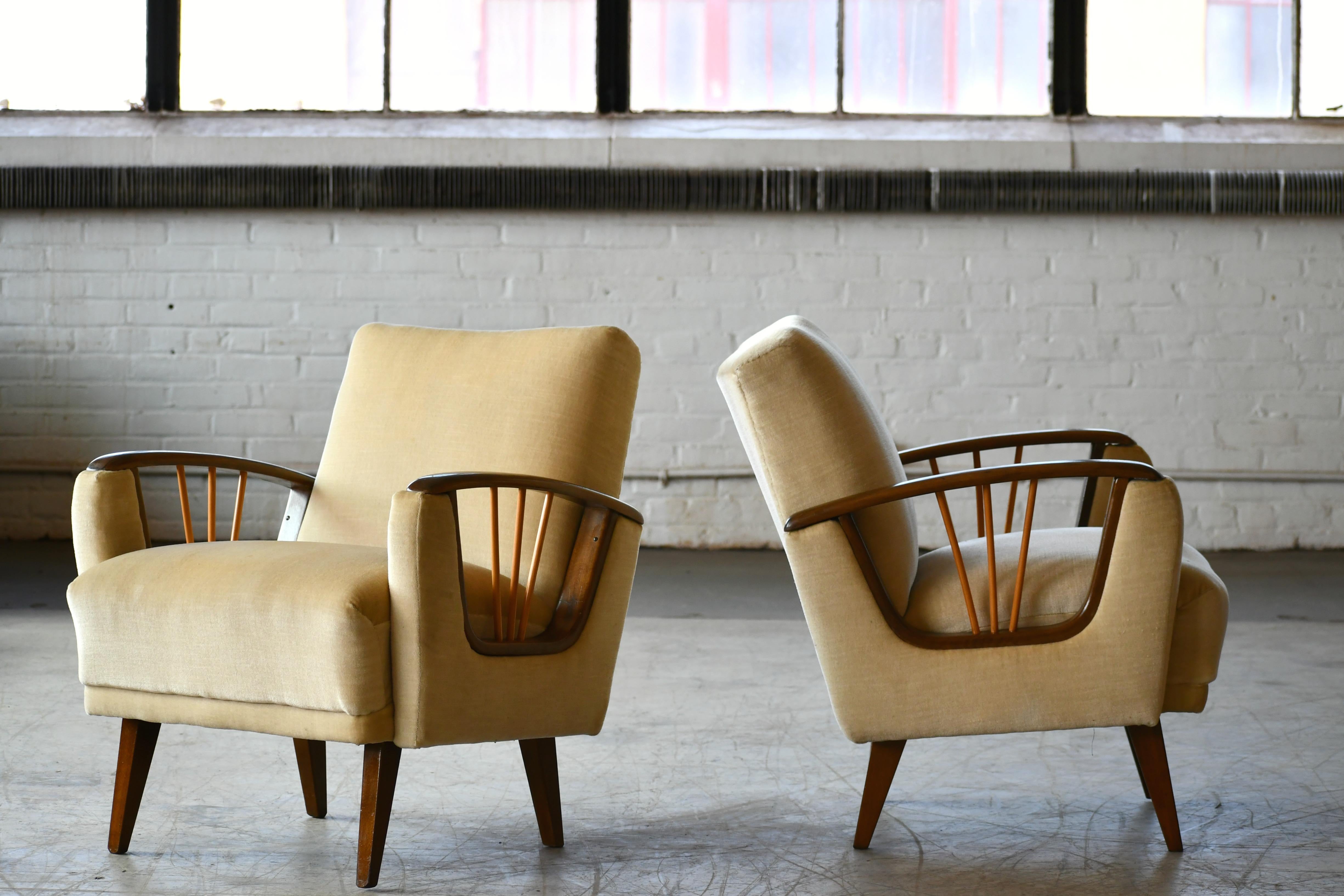 Charming pair of lounge chairs in the style of Paolo Buffa. The rectilinear armrests were much of a hallmark of Paolo Buffa and while he would probably have designed a much deeper chair these two are very interesting. We found them in Denmark but we