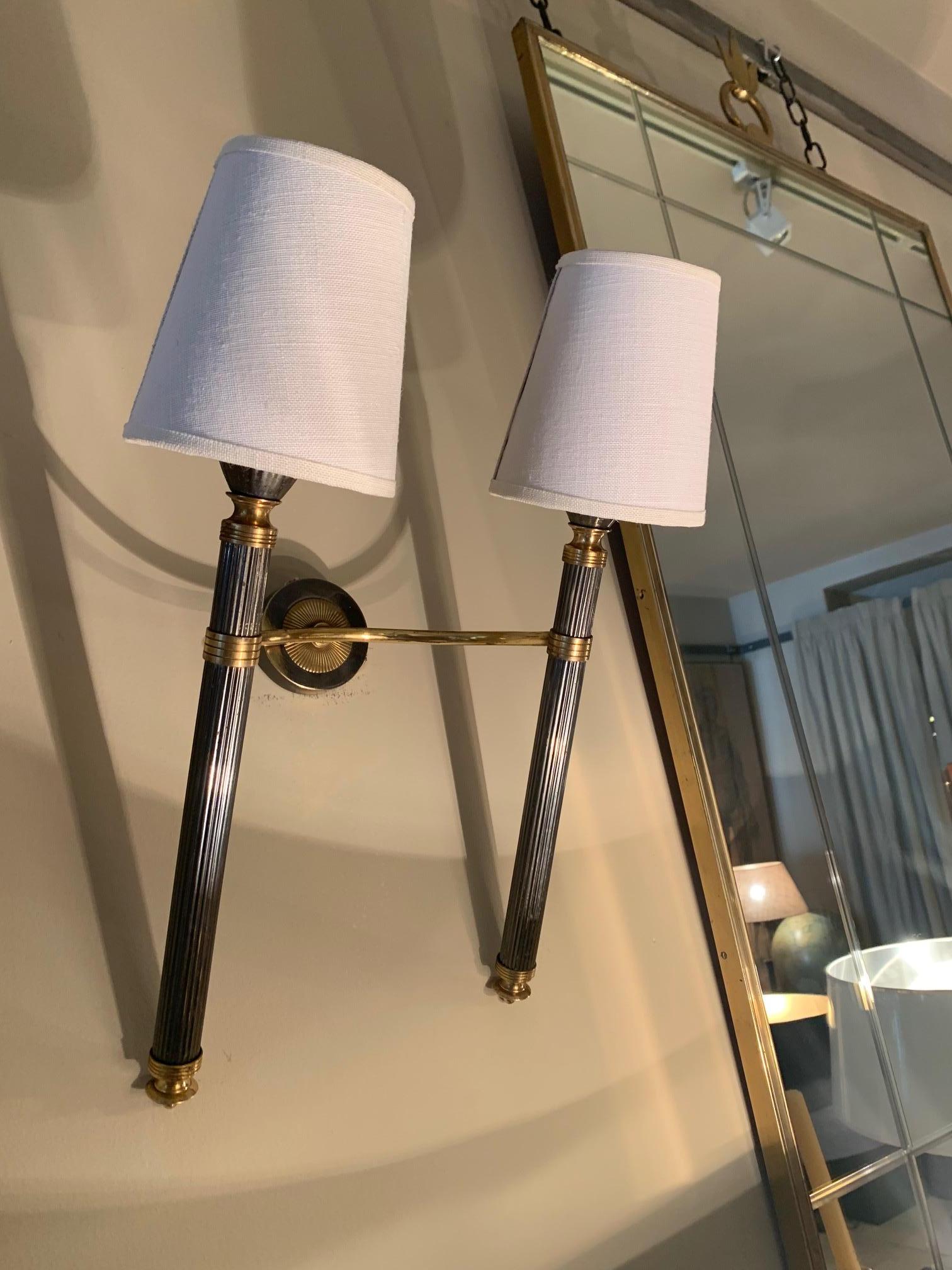Pair of elegant double wall sconces by Maison Lunel in gilded metal, lacquered and brass, broken white lamp pantalls with gilded interior, 40 wat max, newly wired.