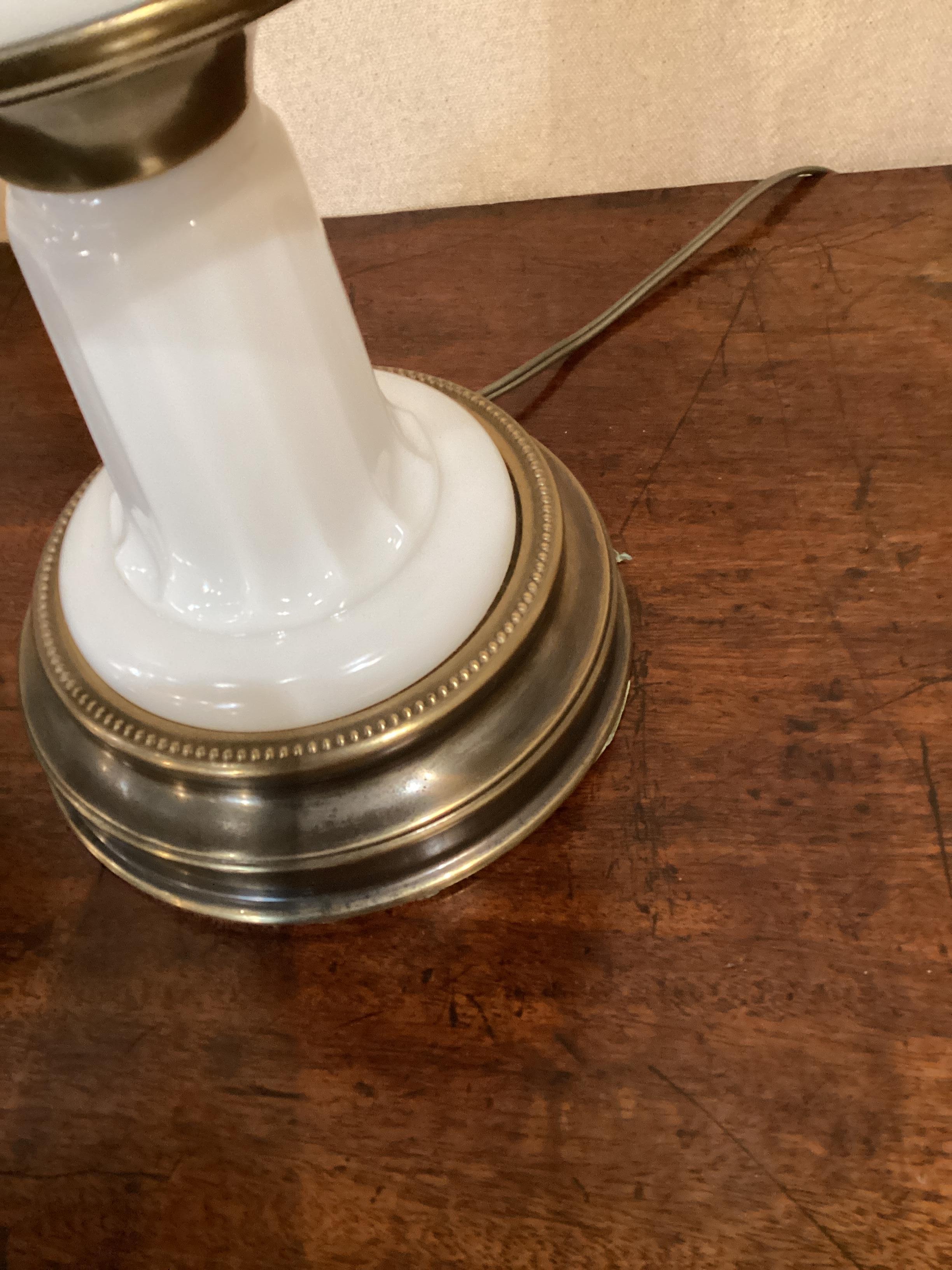 Pair of Mid Century Paul Hanson White Opaline Lamps. These lamps were made by Paul Hanson in the 50/60s after earlier examples of 19th Century oil lamps. They are wired and in working condition. They measure 24” to the bottom of the harp.