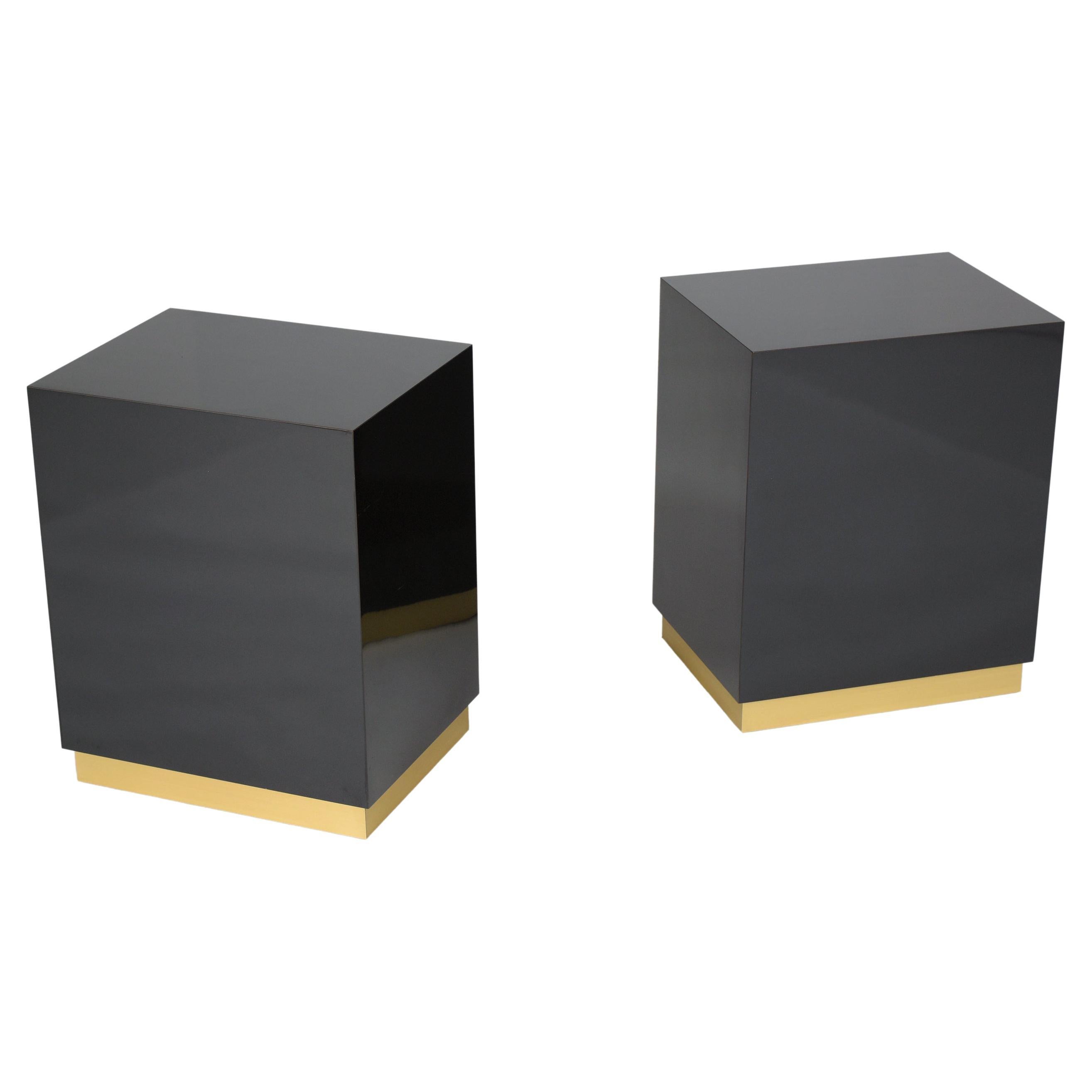 Extraordinary two mid-century modern black end tables in great condition hand-crafted out of laminate wood and are in good condition. This pair of sleek vintage side pedestal tables features rectangular design table-tops covered in ebonized color