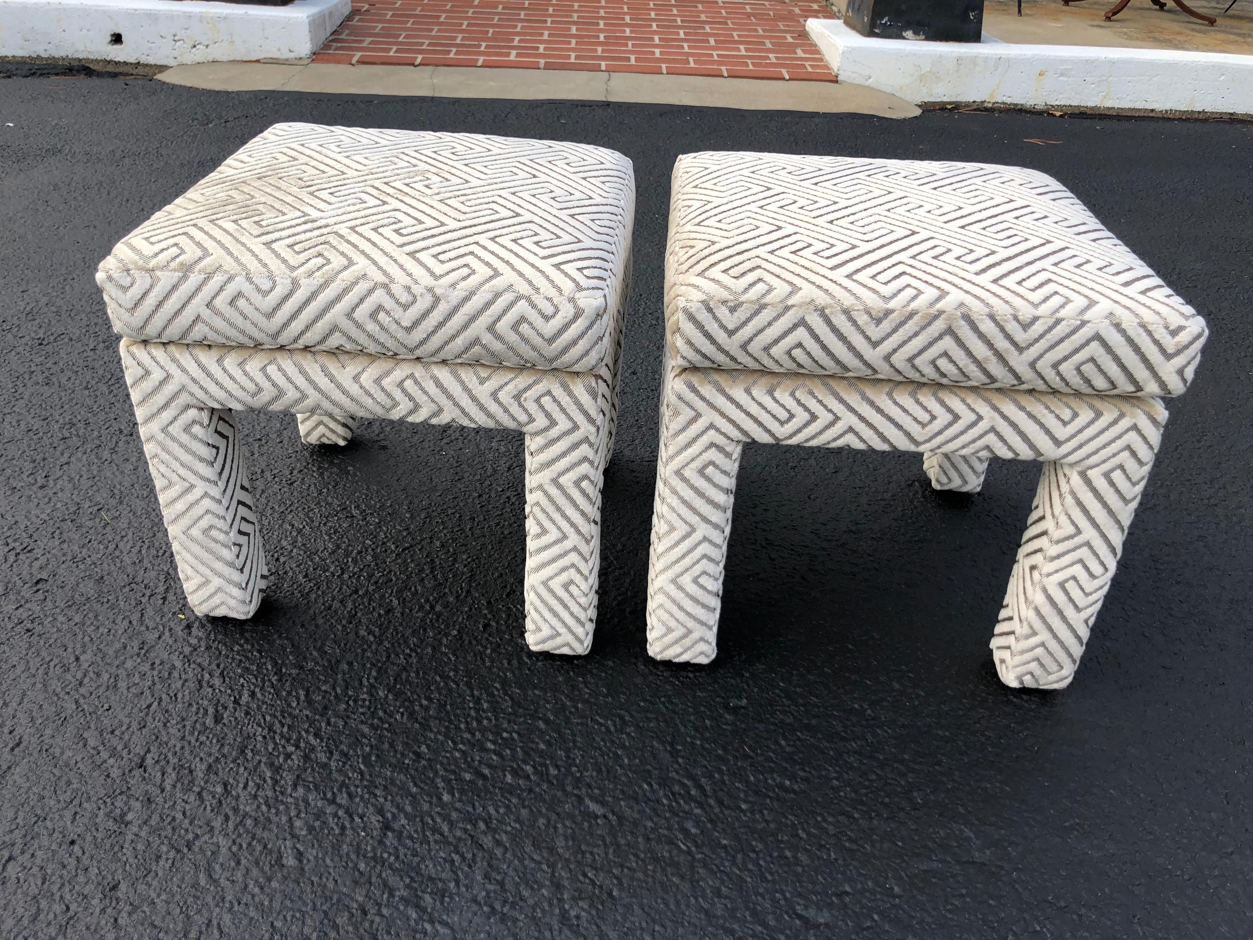 Pair of Mid Century Modern pillow top ottomans in the Parsons design. These are square in shape and newly upholstered. Gorgeous champagne two toned with a geometric design thick velvet- like upholstery. Mint condition. One stool may look darker that