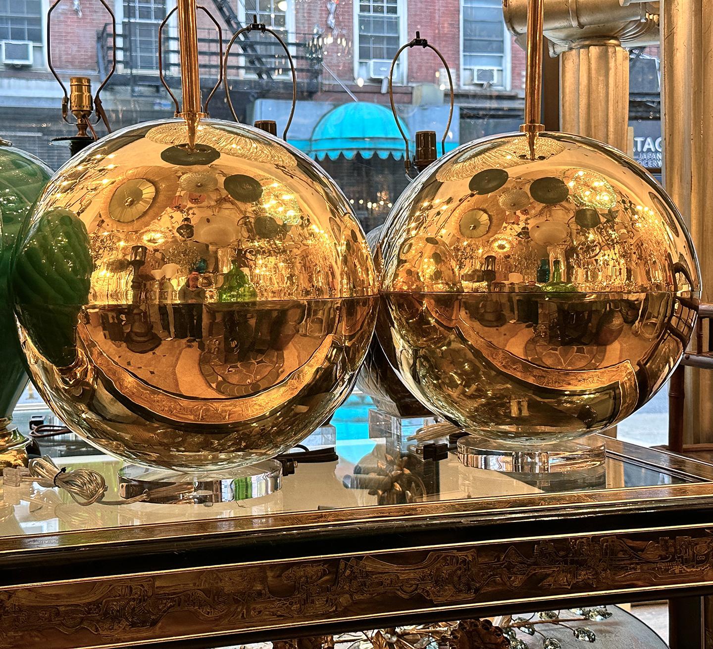 Pair of Italian circa 1970's large, polished bronze sphere lamps with lucite bases.

Measurements:
Height of body: 17