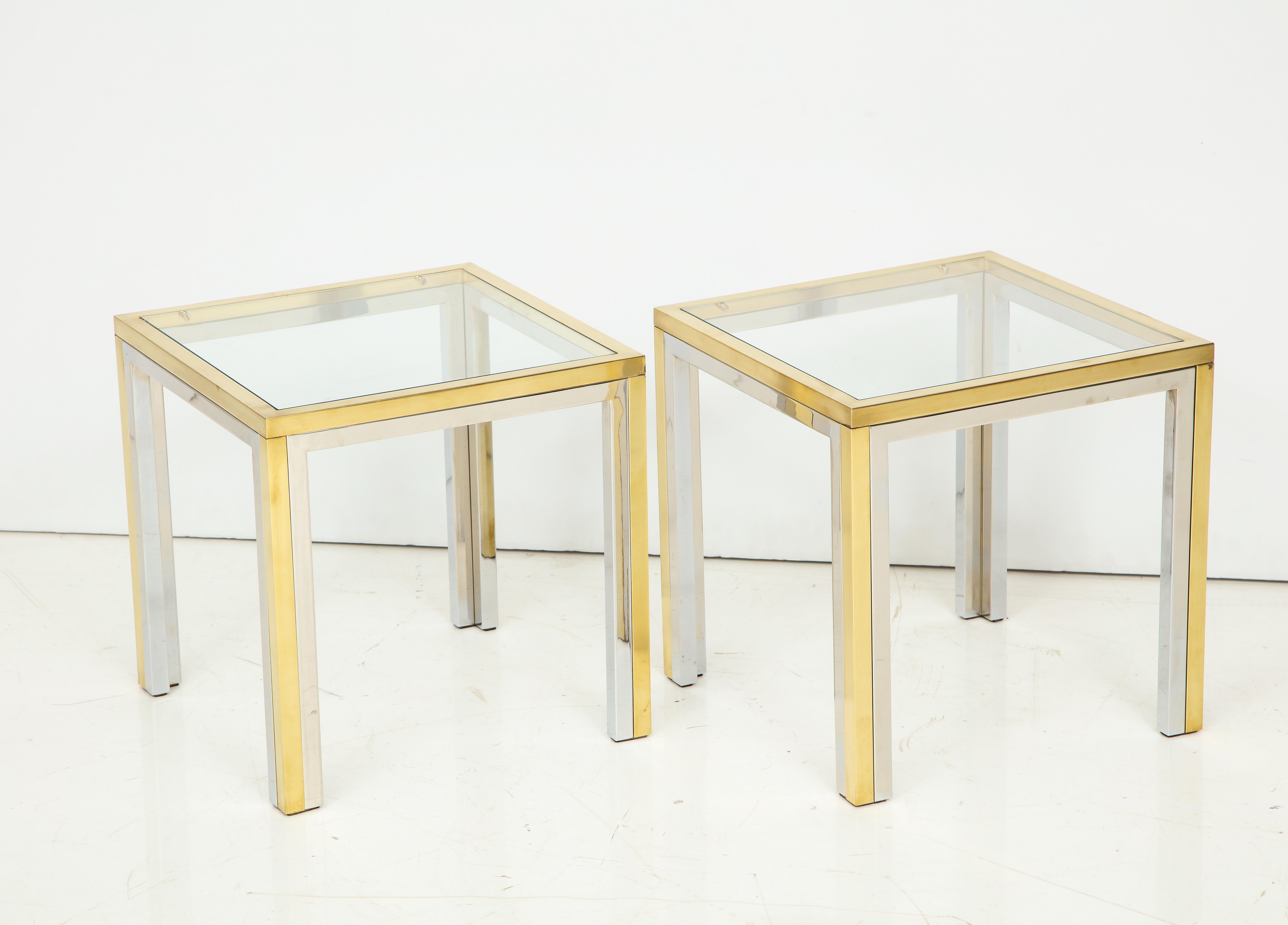 Pair of midcentury polished chrome glass and brass tables.