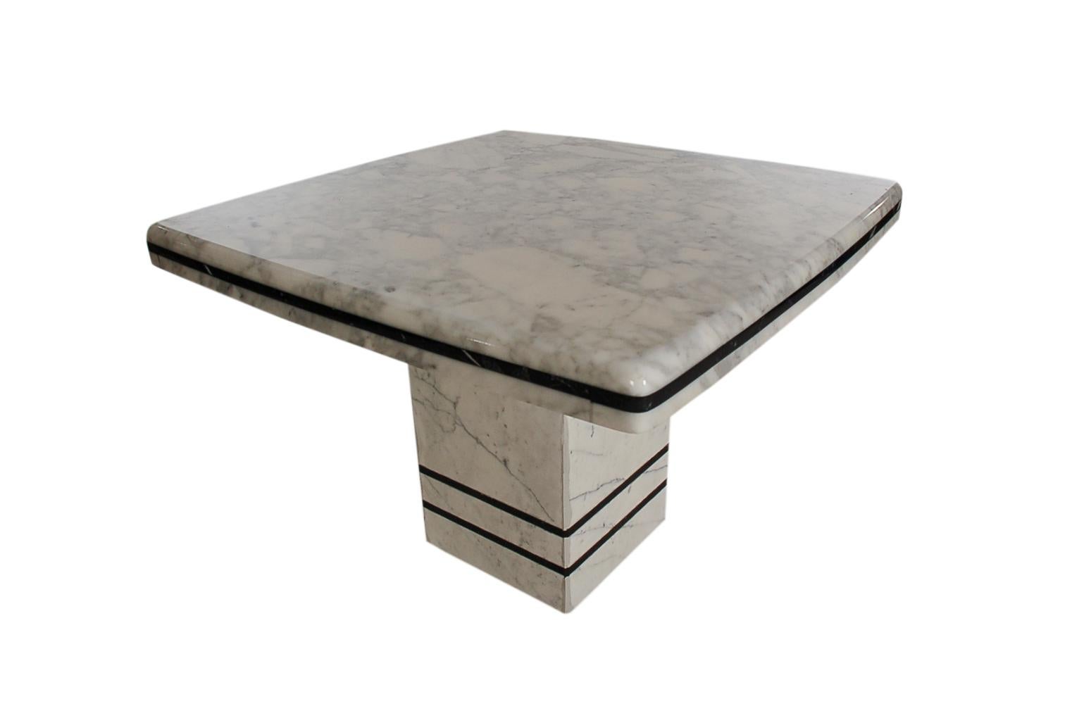 A sleek and modern matching pair of modern end tables from Italy, circa 1980s. These feature heavy marble construction with gorgeous veining. Price includes the pair as shown.
