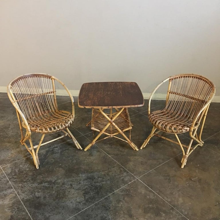 Pair of antique rattan armchairs combine comfort and charm to fit a casual decor. The unique oblong shape of the chairs is achieved by expertly shaping and bending the bamboo to create a comfortable and sturdy seat, circa mid-1900s
Measures: 28 H x