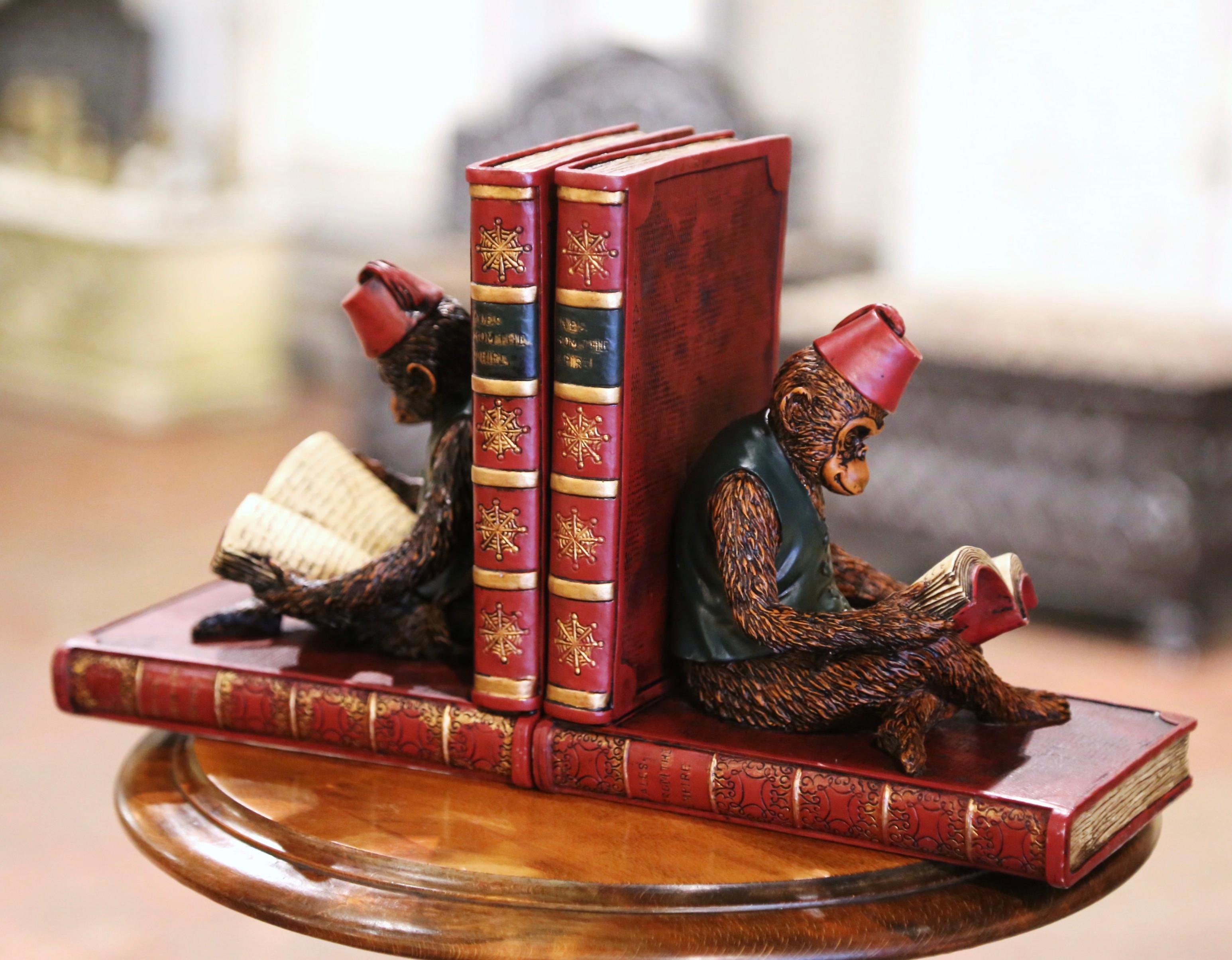 Elevate your space with these captivating hand-painted heavy plaster bookends, showcasing a delightful depiction of two monkeys engrossed in the Tales of the Empire books. Crafted in France circa 1960, this work of art mesmerizes with its vibrant