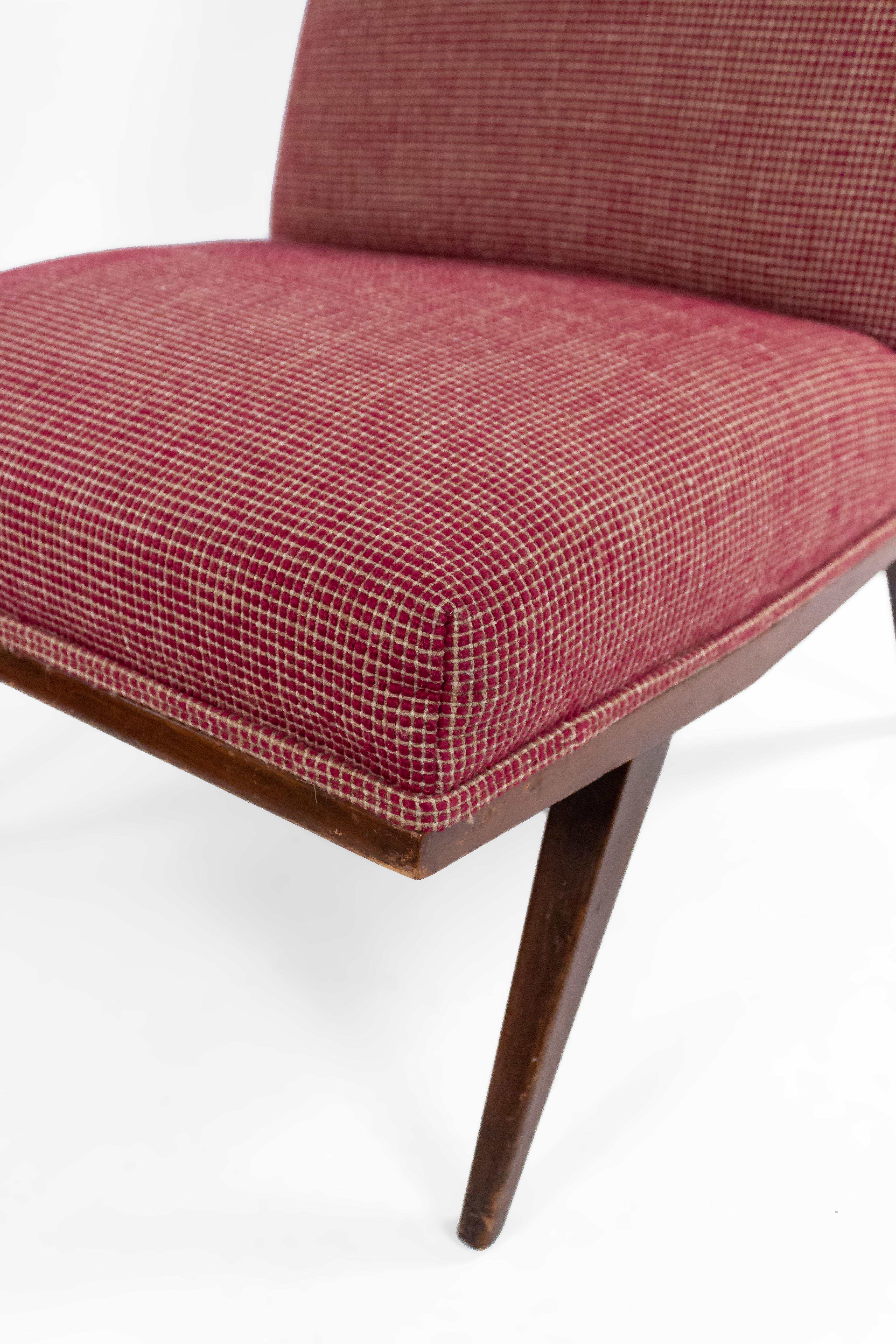 Pair of mid-century slipper chairs with red and beige geometrically patterned upholstery and tapered walnut legs.