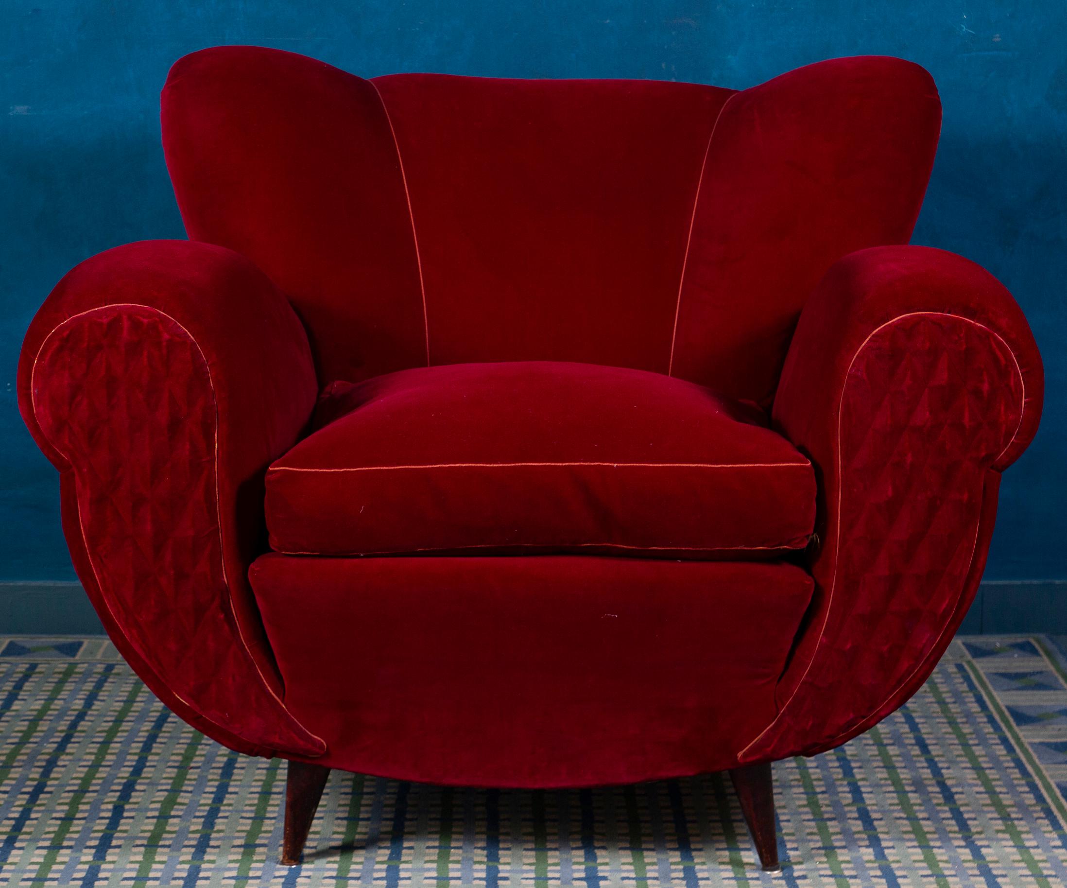 Very comfortable pair tulip shape red velvet of armchairs with scrolled hand holds .
 Soft and beautiful original vintage red velvet upholstery. The conical legs are in original condition. These elegant silhouette lounge chairs would compliment
