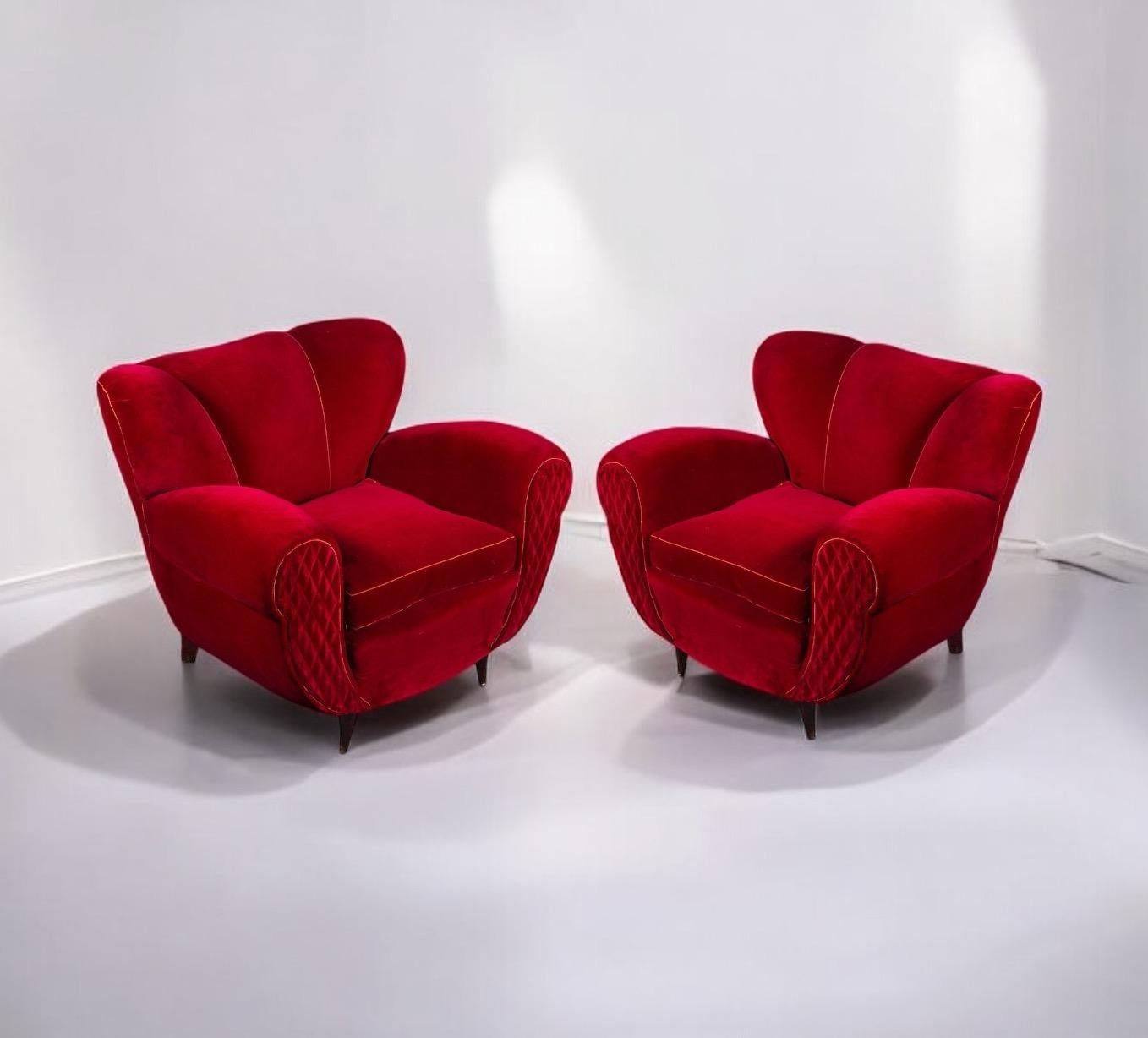 Very comfortable pair tulip shape red velvet of armchairs with scrolled hand holds .
 Soft and beautiful original vintage red velvet upholstery. The conical legs are in original condition. These elegant silhouette lounge chairs would compliment