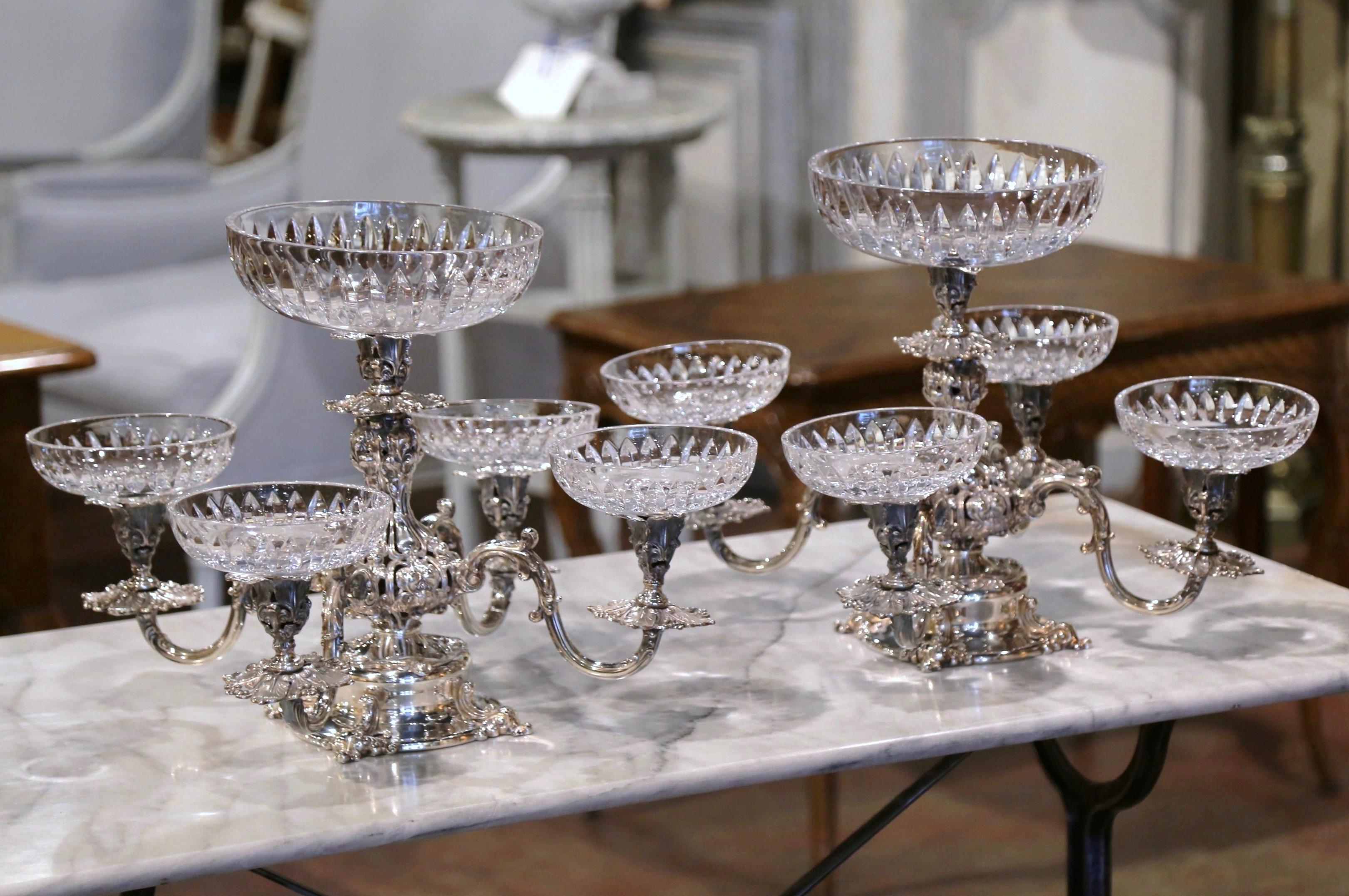 Decorate a dining table with these elegant five-bowl antique epergnes! Created in the United States by Reed and Barton, circa 1960 and made of copper with silver-plate, the centerpiece stand on a pedestal decorated with floral and vine motifs over a