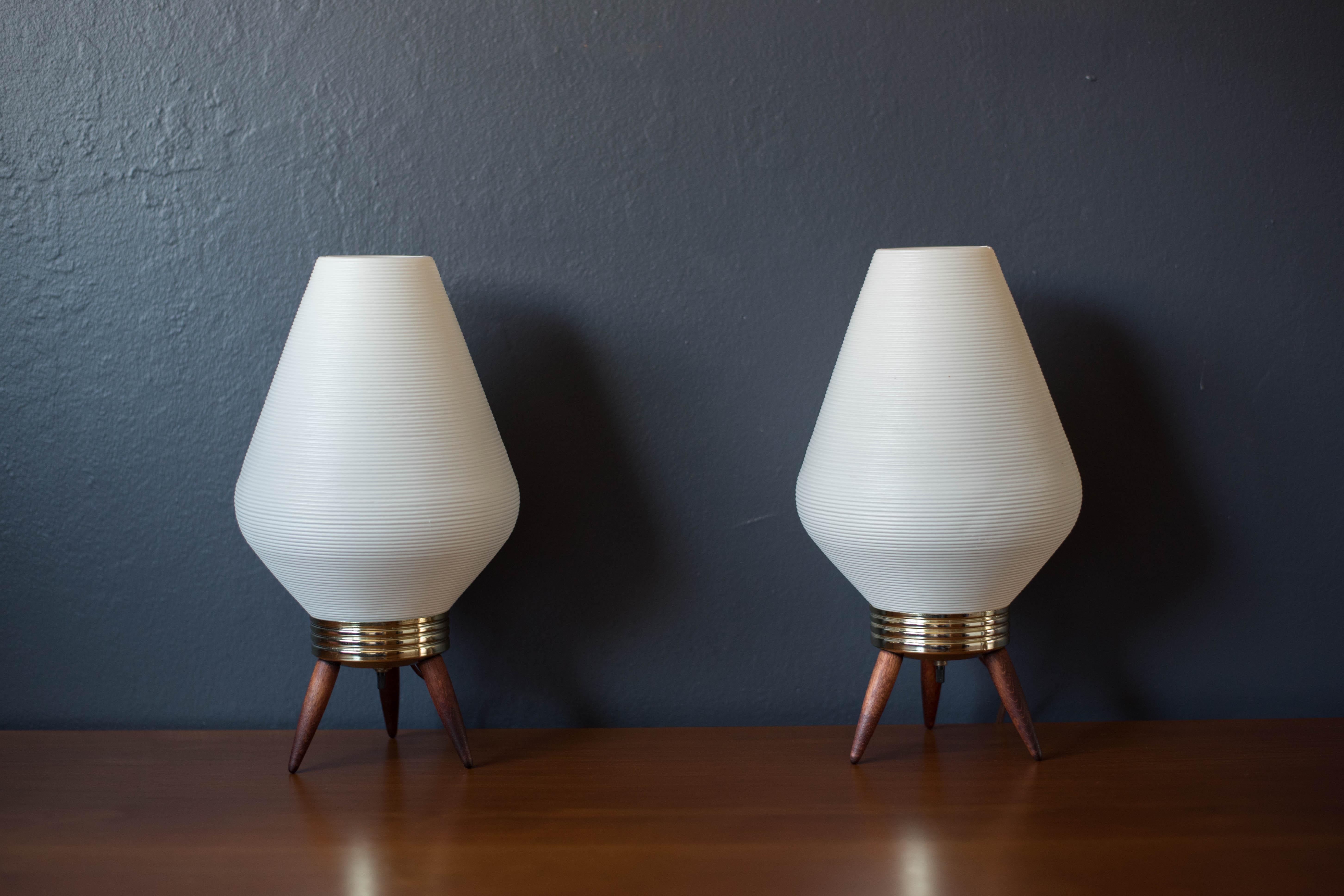 Vintage pair of beehive tripod accent table lamps circa 1960's. This glowing set will light up any space accessorized with bedroom nightstands or living room side tables. Features a white beehive plastic diffuser shade and a brass plated aluminum