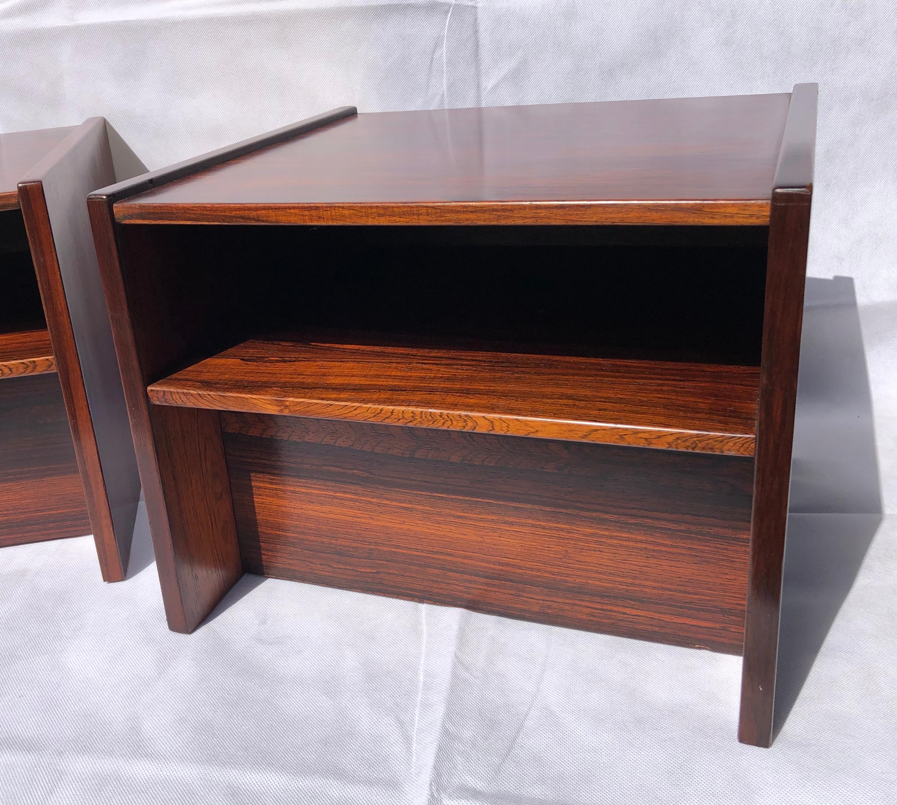 Pair of Danish Mid Century rosewood bedside tables / nightstands, 1970s

Pair of stunning midcentury rosewood bedside tables cabinets, 1970s. 
These are designed to sit against a wall, square in shape, below the top surface is there is a cubby