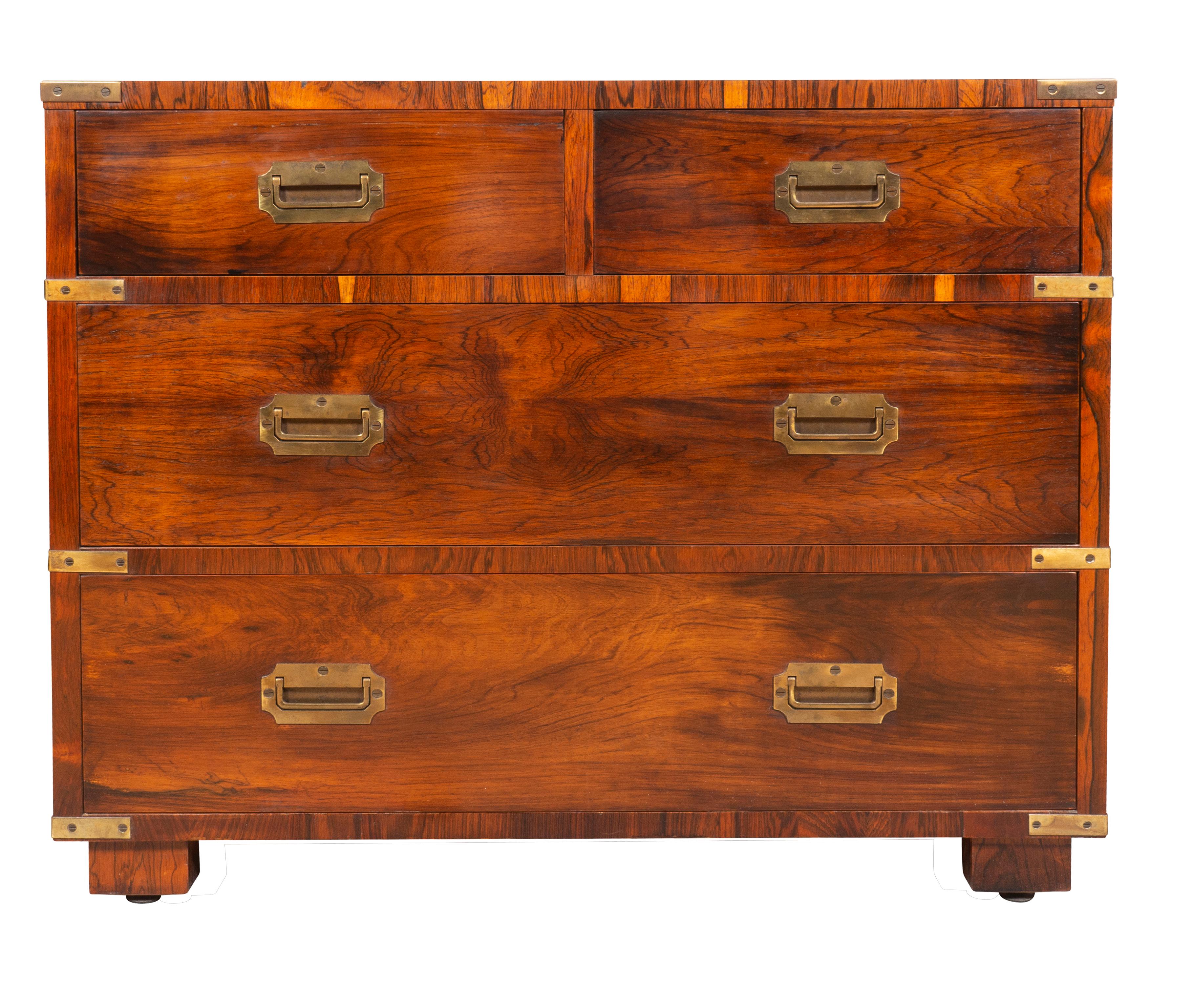 Each with a rectangular top with brass corners over two over two long drawers all with recessed brass handles. Side handles. Block feet. Labeled in drawer by Maker. Brazilian rosewood.