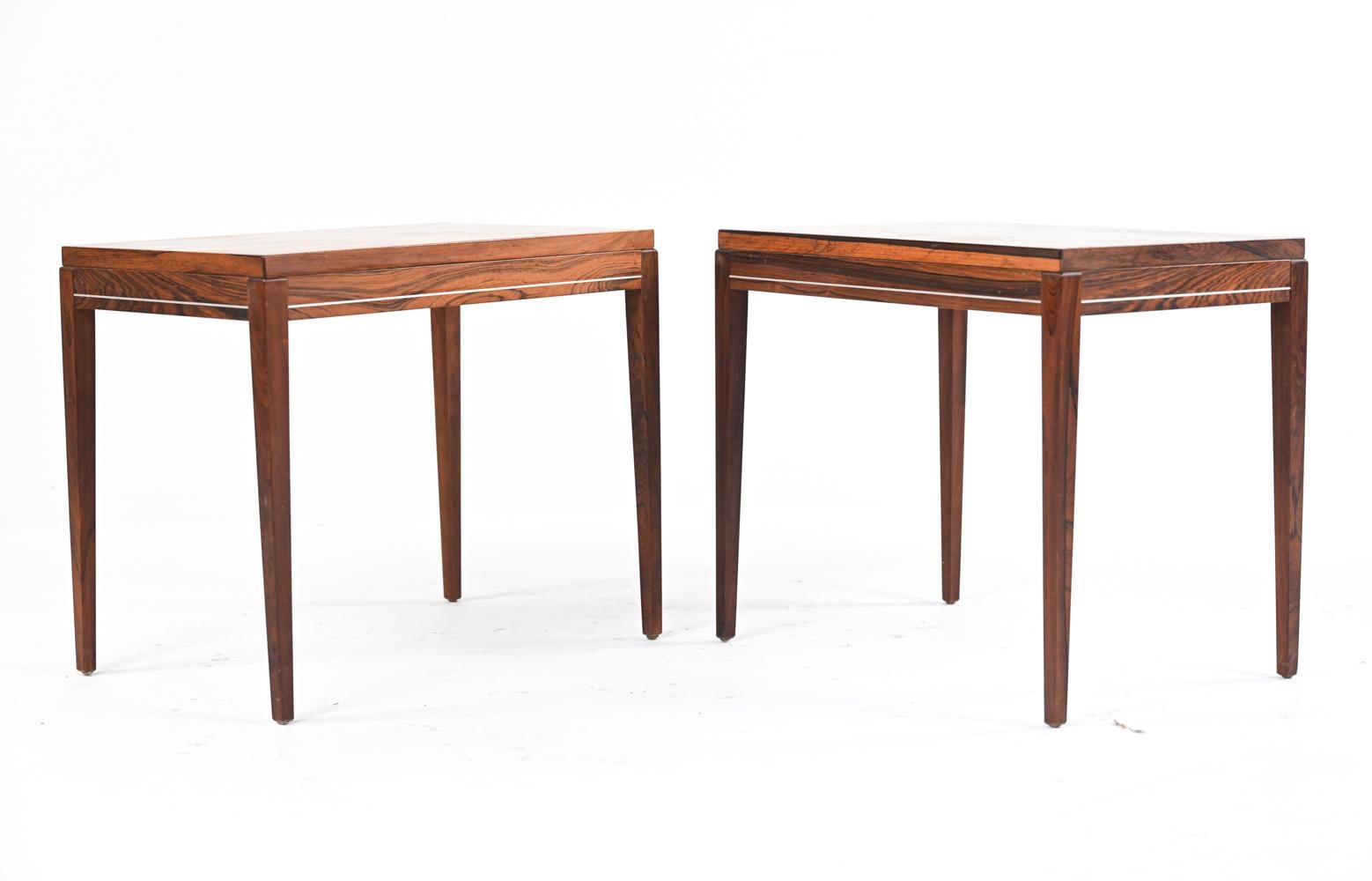 A unique and unusual pair of Mid-Century Modern rosewood side tables with delicate banded aluminum inlay that gives off a warm glow in the light. Apparently unmarked, in the style of Harvey Probber, Edward Wormley, or Rud Thygesen.