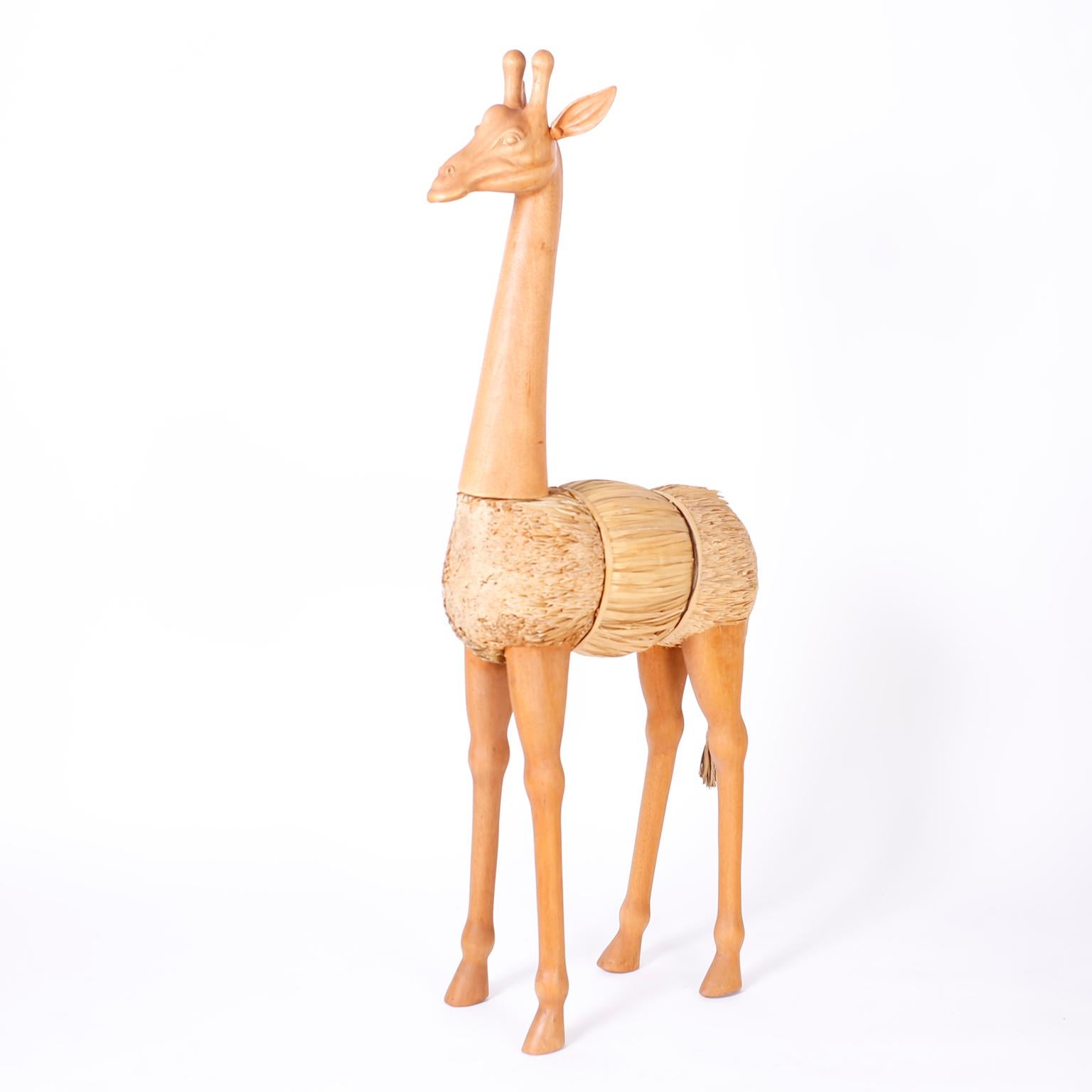Stand out pair of mid century giraffes one standing and one grazing with a unique construction of shaved reed bundles and having carved wood heads, necks, and legs.

Standing Giraffe: H: 60, W: 28, D: 8
Grazing Giraffe: H: 34, W: 43, D: 9.