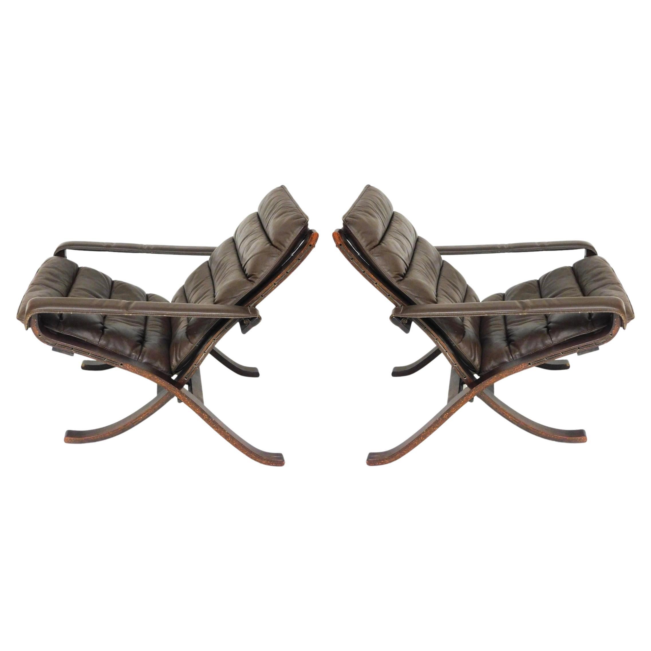 Pair of Mid century Scandinavian modern brown leather Safari flex lounge chairs 