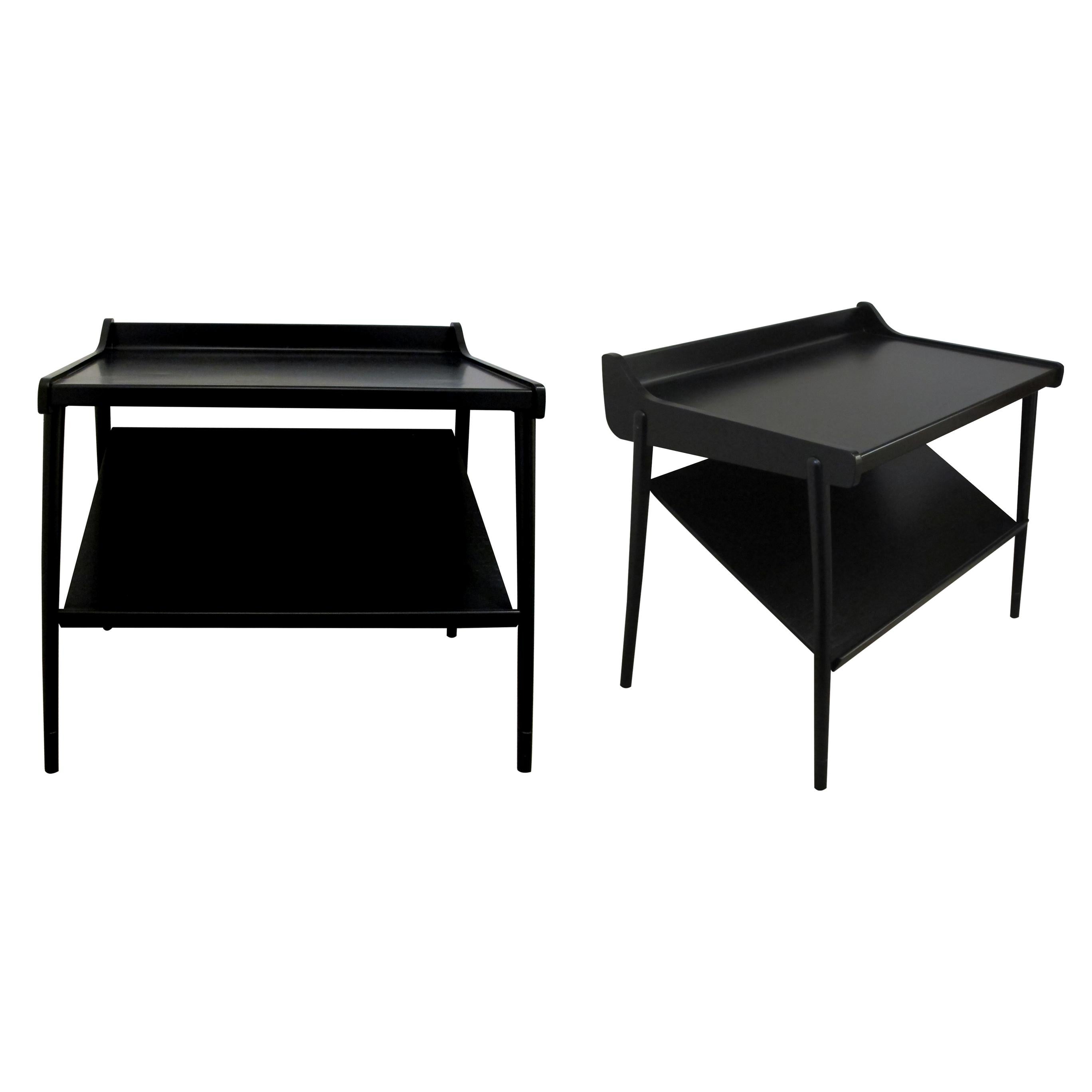 A pair of ebonized midcentury side or bedside tables with a structural two-tier design. The two tiers are mounted on four thin spindle legs. Very elegant tables which will fit into most settings. 

Size: H 57 cm x W 60 cm x D 40 cm.
 