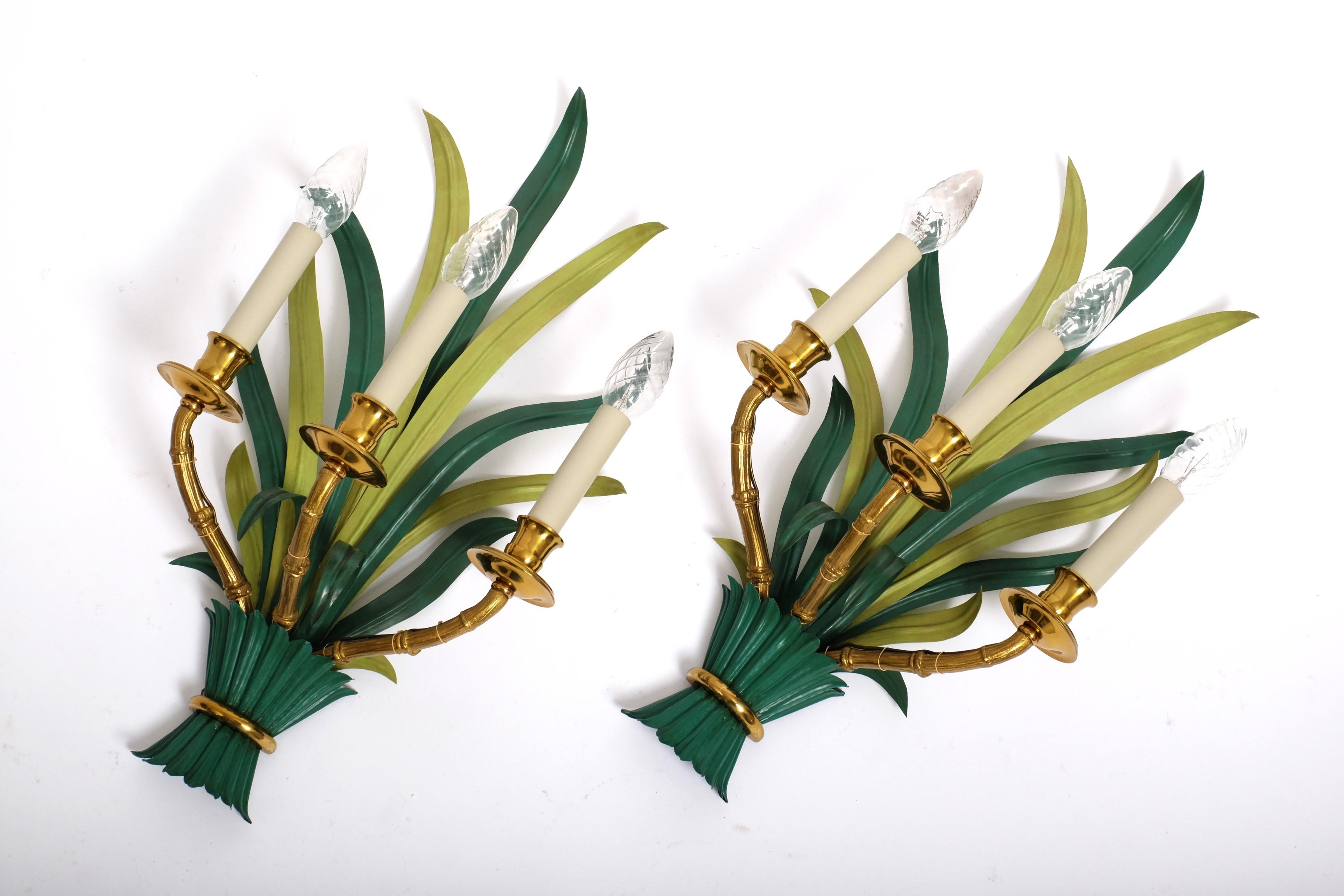 A pair of extraordinary sconces by Maison Bagues with green painted long palm leaves and three bamboo shaped arms of brass.

Stunning lamps and a real asset to any home.

Condition:
Good vintage condition with some wear to paint consistent with use