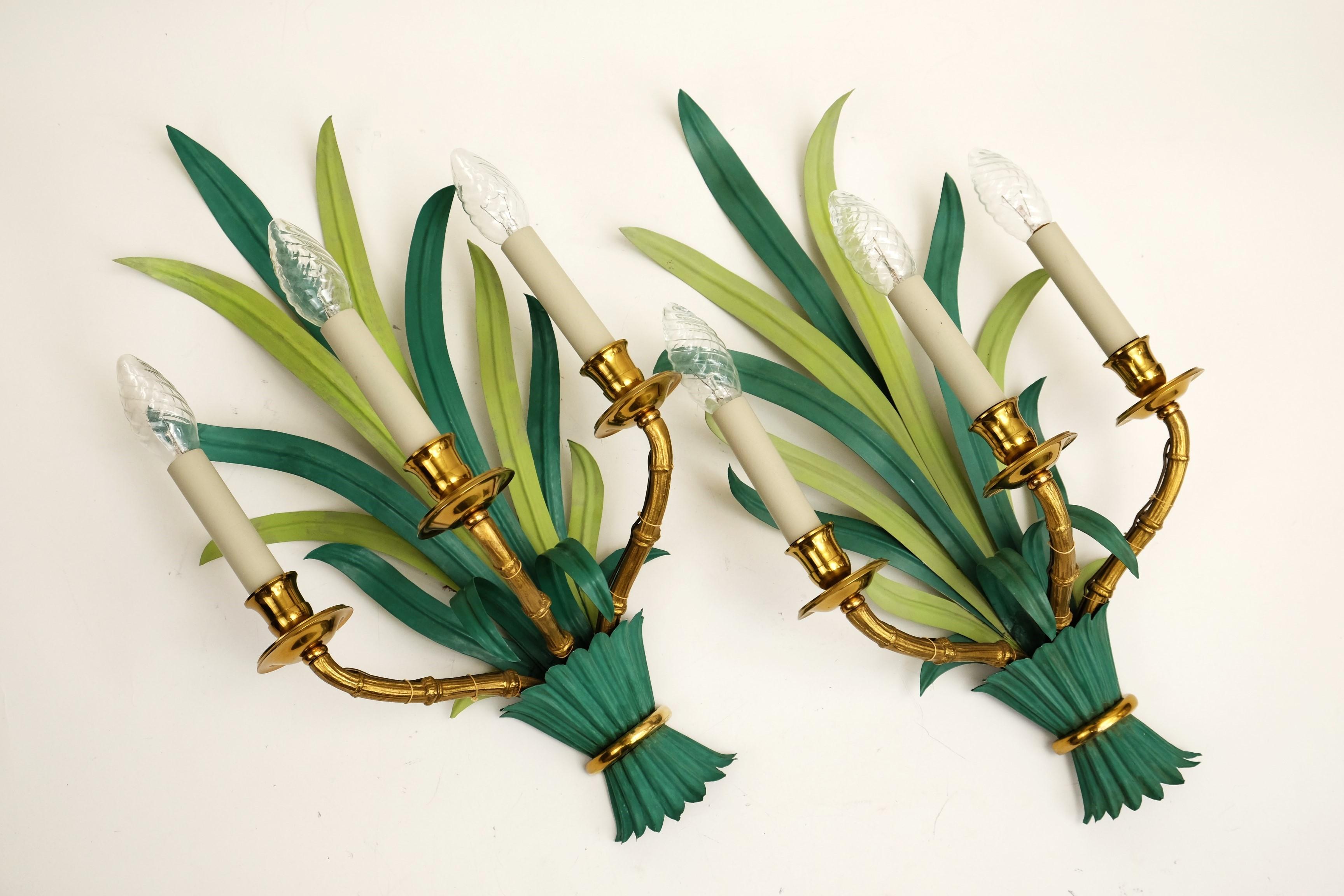 A pair of extraordinary sconces by Maison Bagues with green painted long palm leaves and three bamboo shaped arms of brass.

Stunning lamps and a real asset to any home.

Condition:
Good vintage condition with some wear to paint consistent with use
