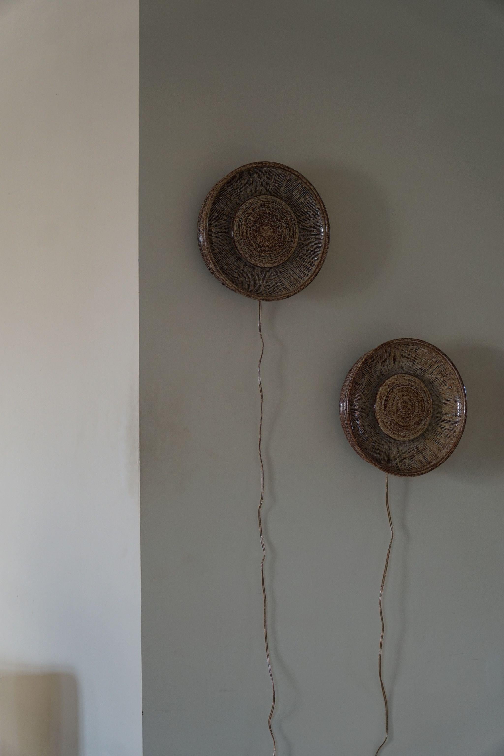 A pair of danish ceramic wall lamps from the 1970s, produced by the Danish company Dagnæs. These decorative wall lamps is made of ceramic in various shades of brown. 

The pair is in a great vintage condition. 

Other honorable mentions from