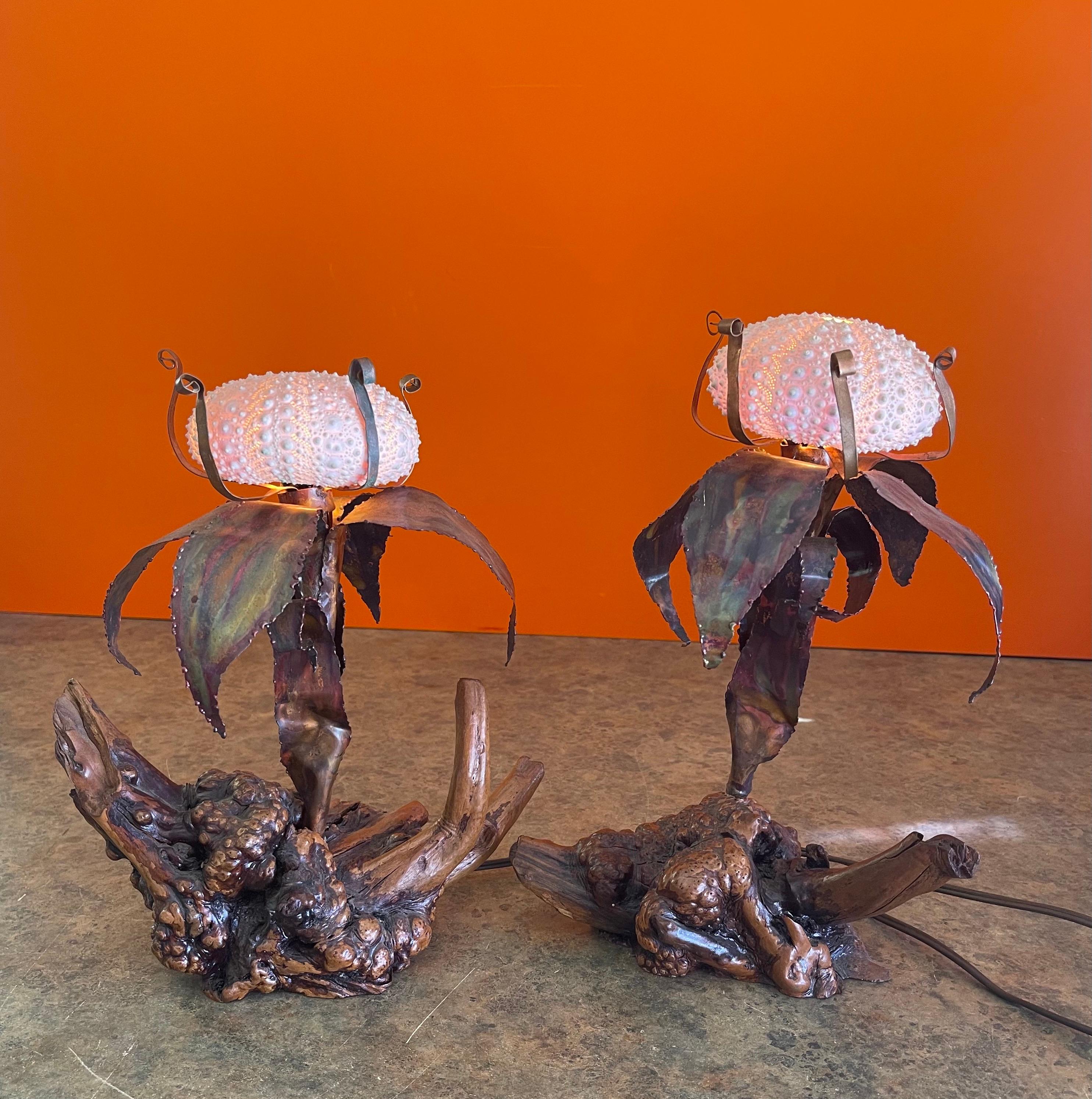 Pair of mid-century sculptural sea urchin table lamps by Curtis Jere and Artisian House, circa 1970s. The pair have burlwood bases with copper foliate and include the original sea urchin lampshades. The lamps are in very good vintage condition and