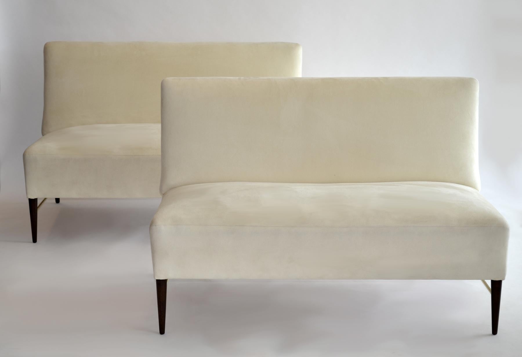 Rare Pair of Predictor Line Settees by Paul McCobb 1950s. 
Handsome, minimal design, armless pair of loveseat-size settees / sofas perfect to split apart or use as a single 8.5-foot sofa. Turned birch legs with brass stretchers. Off-white ultrasuede