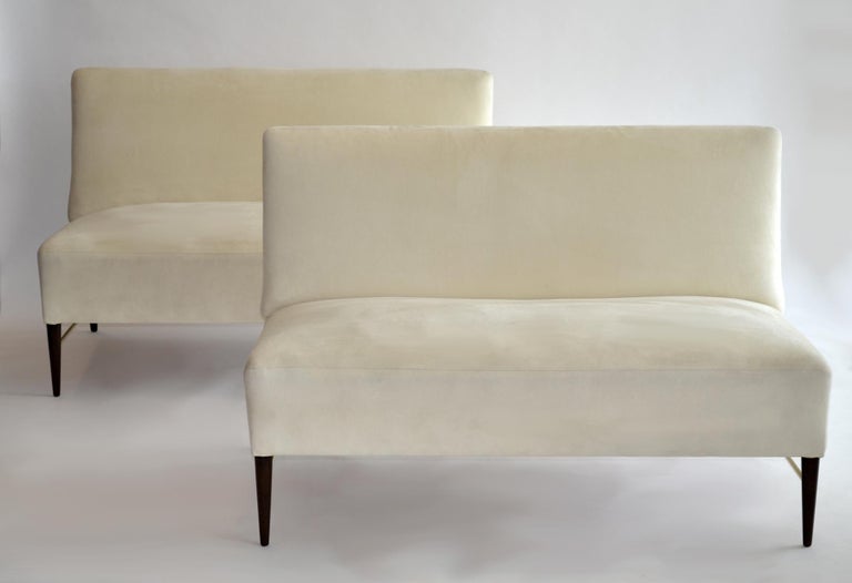 Rare Pair of Predictor Line Settees by Paul McCobb 1950s. 
Handsome, minimal design, armless pair of loveseat-size settees / sofas perfect to split apart or use as a single 8.5-foot sofa. Turned birch legs with brass stretchers. Off-white ultrasuede