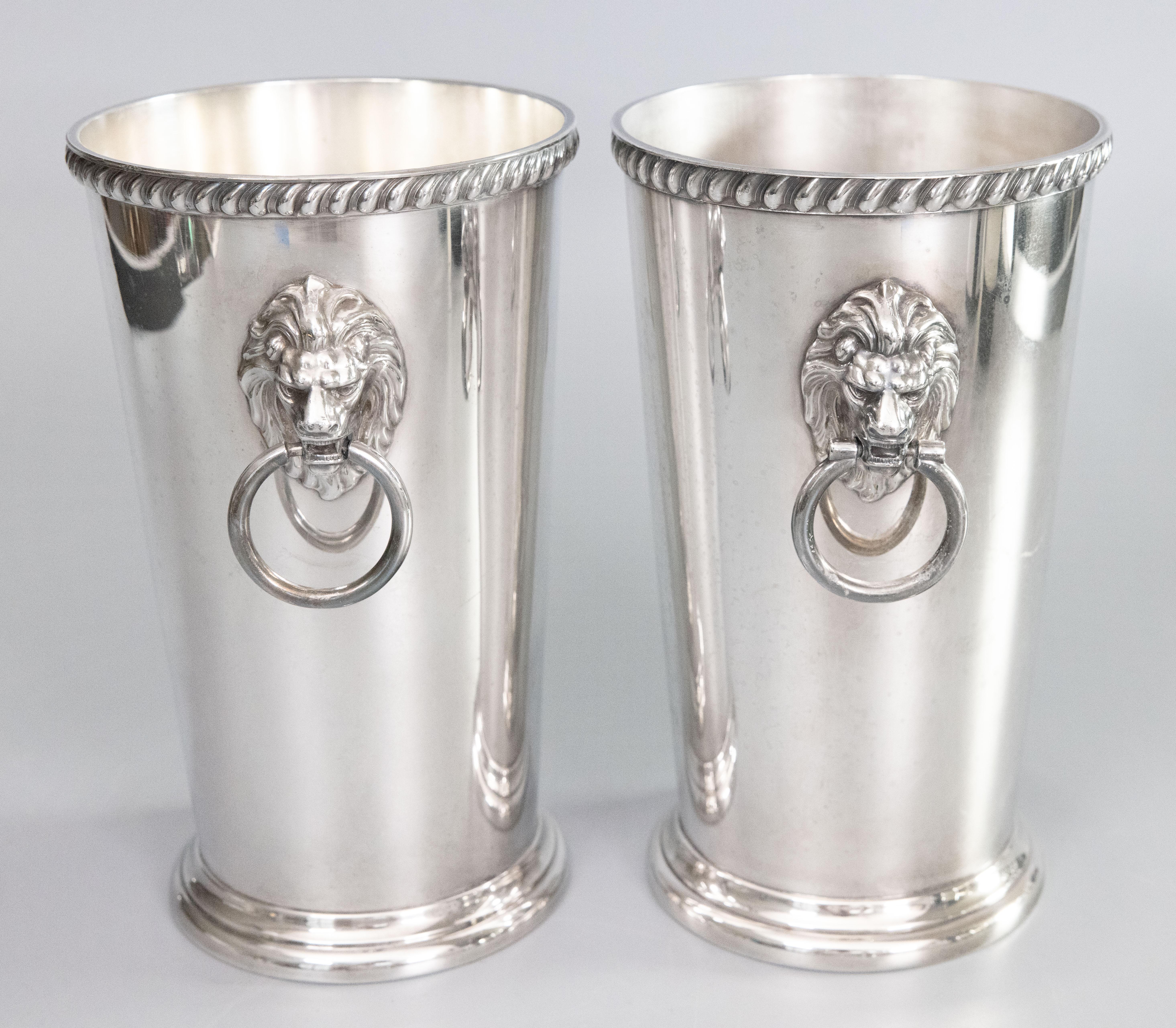 A lovely tall pair of mid-century silverplated champagne buckets or wine coolers with lion head ring handles. Maker's marks on reverse. These fine quality ice buckets are a nice large size, solid and heavy, with exquisite details in the lion heads