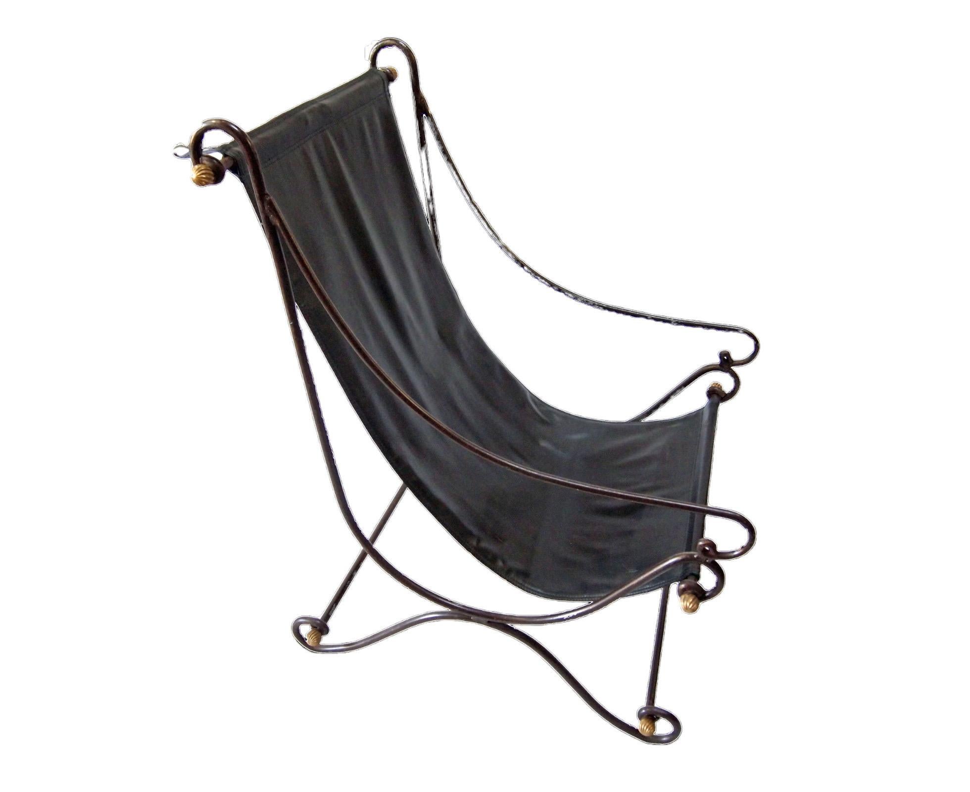 Pair of Mid Century Sling Lounge Chairs, circa 1970s.
Iron frame with connecting rods finished with gilt ribbed bronze ball finials. Each chair has simulated black leather seats. The seats can be adjusted by removing the finials and changing the