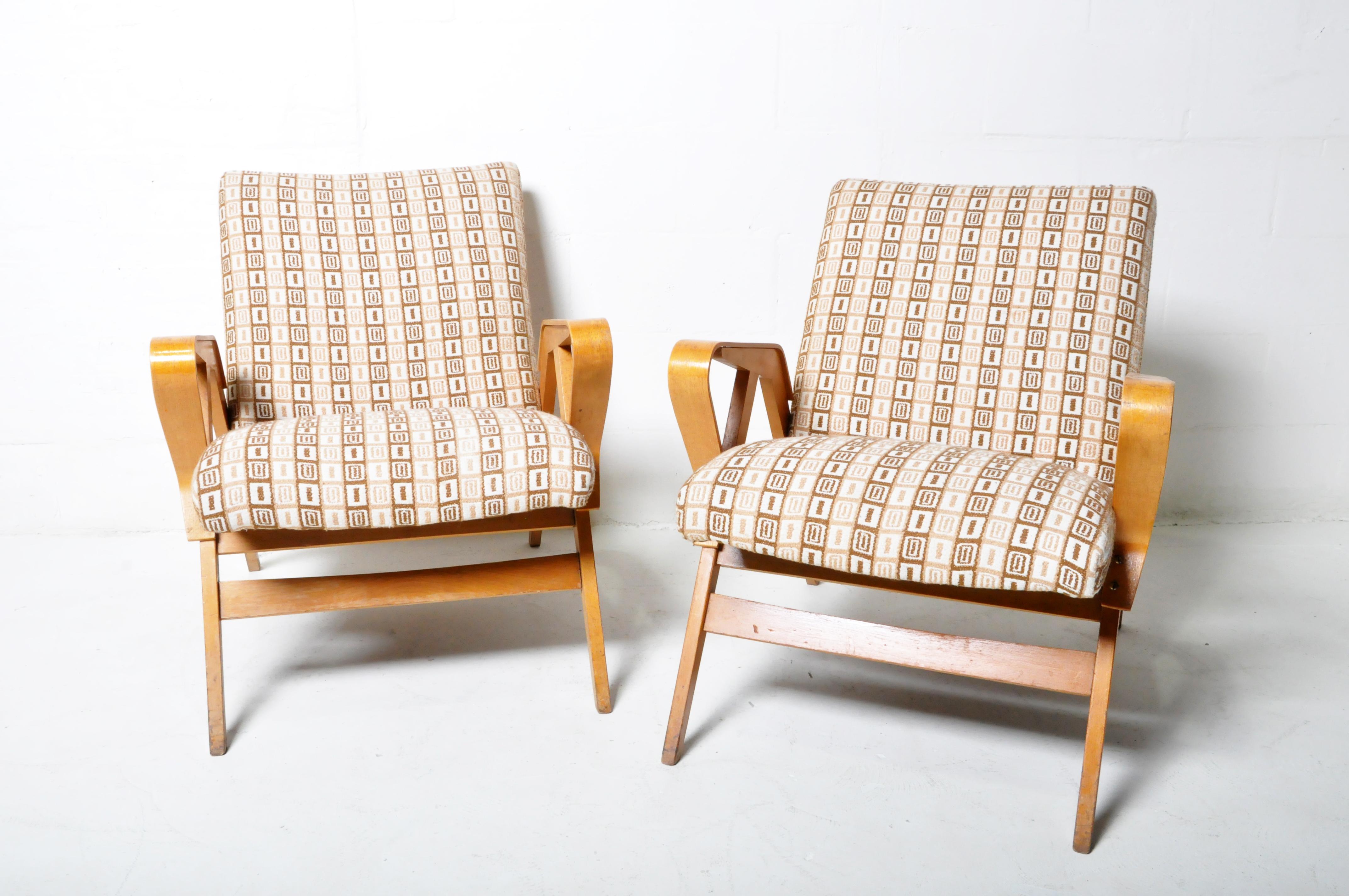 These Mid-Century Modern Czech lounge chairs are made from a solid poplar frame and have bent beechwood arms. They are typical of East-Block 