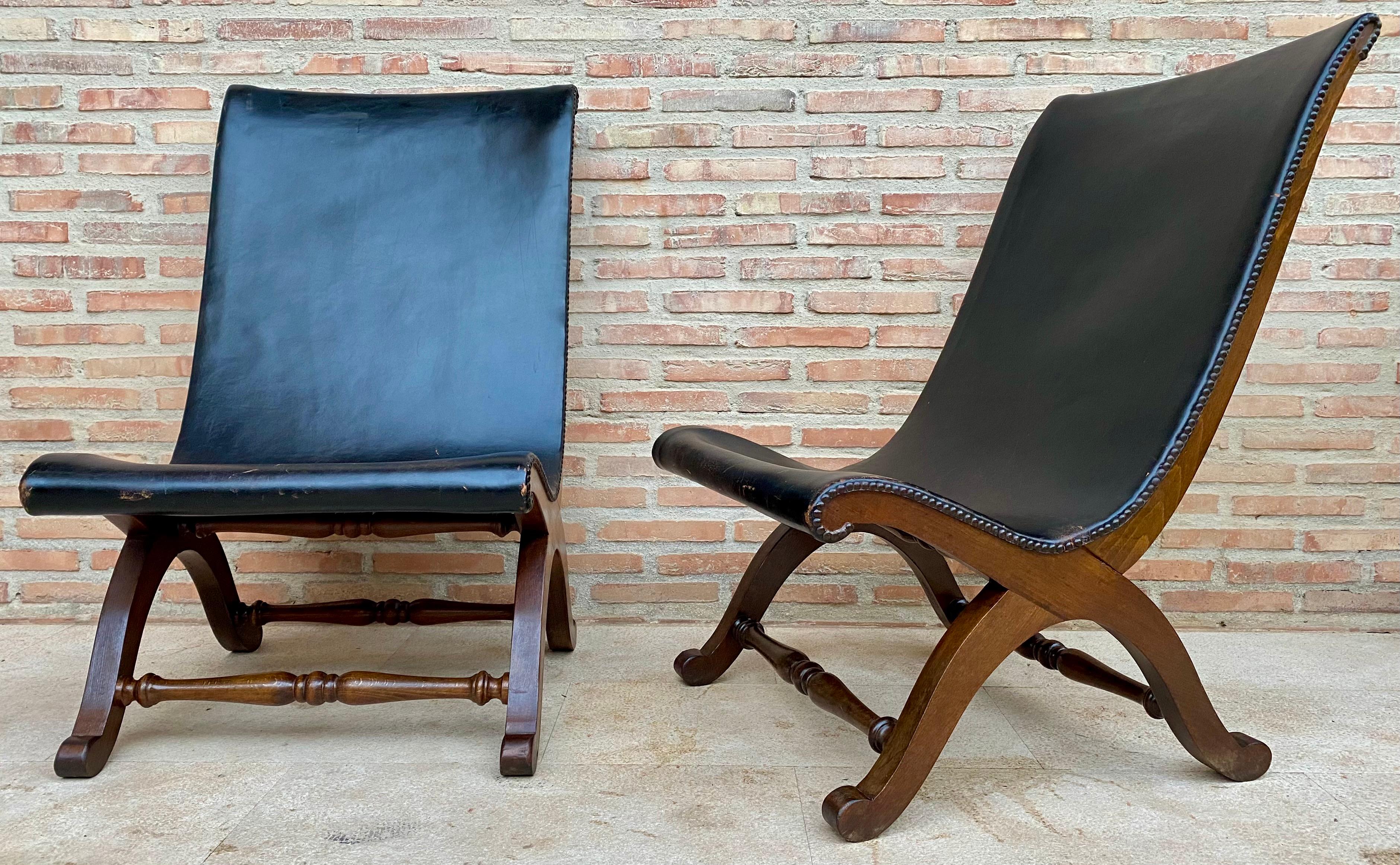 Pair of Spanish black leather armchairs by Pierre Lottier for Valenti, 1940s with brass nail head details and original leather.

Pierre Lottier was born in France before moving to Spain where he worked as a designer, working with the likes of Ava