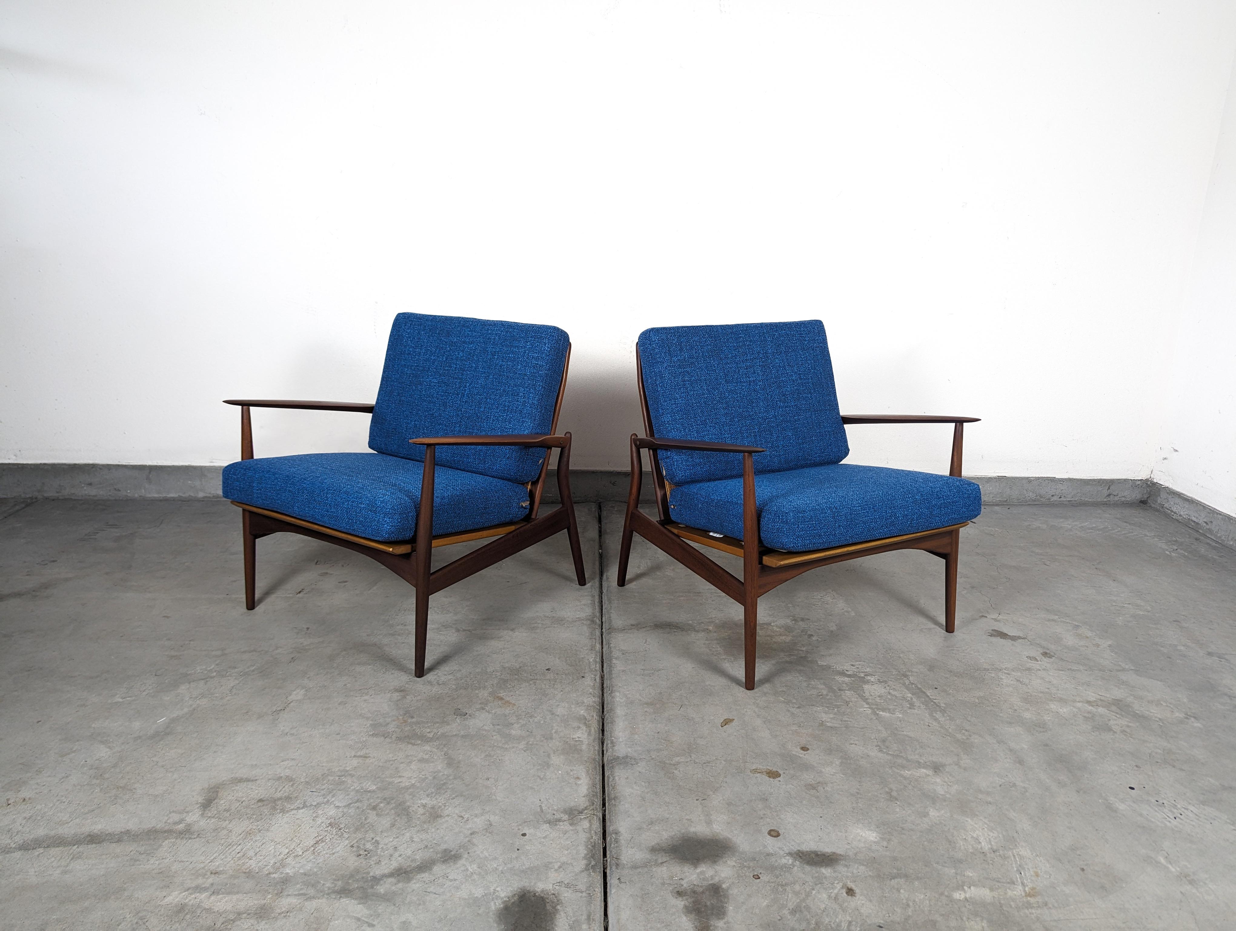 Discover the epitome of mid-century charm with this stunning pair of lounge chairs by the acclaimed Danish designer Ib Kofod Larsen, designed for the esteemed Selig brand in the 1960s. These spear chairs encapsulate the essence of the era, offering