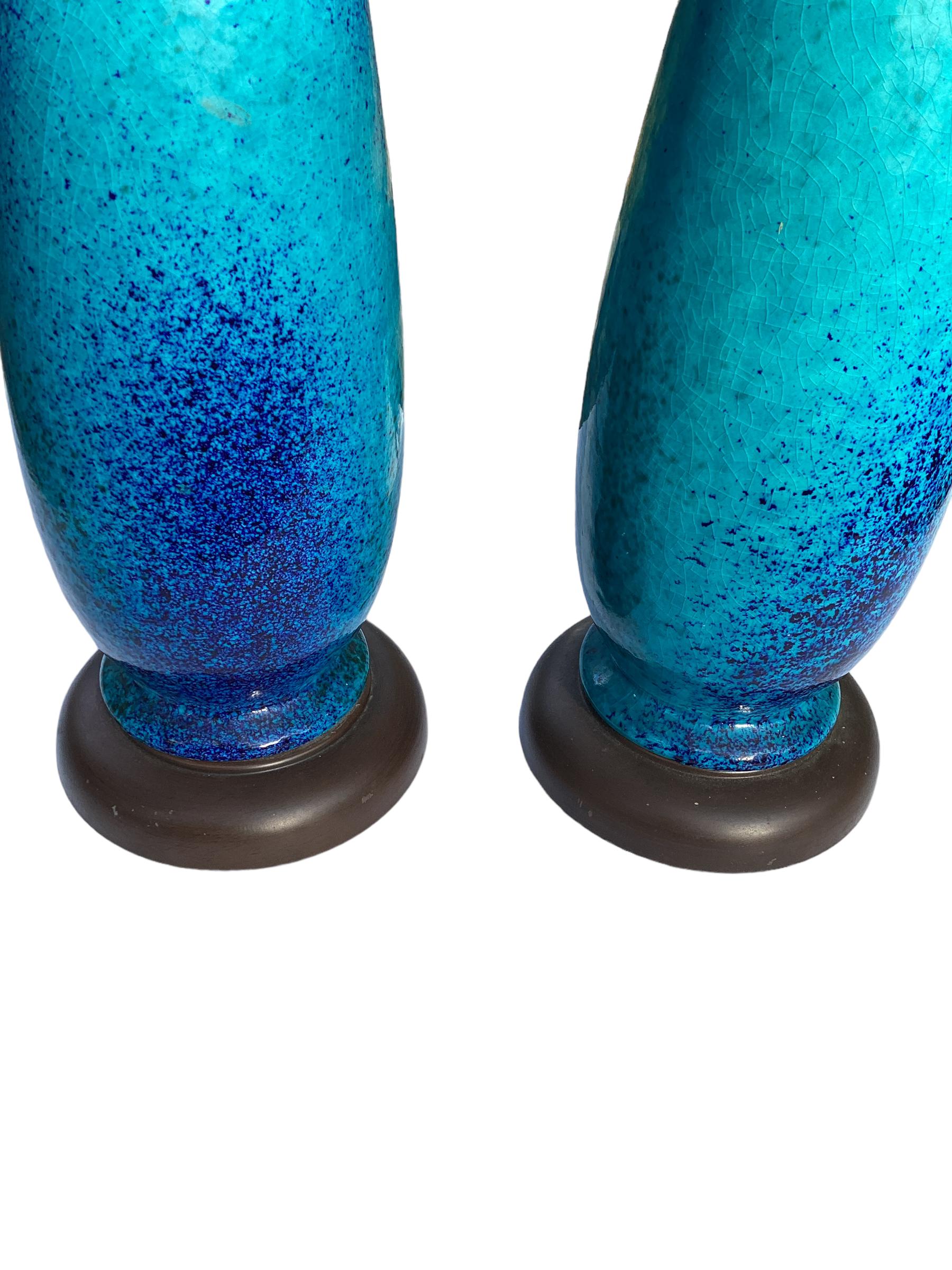 Pair of American mid century classically tailored light blue base color and  dark blue speckled crackle glaze porcelain lamps. New sockets and wiring to USA standards. Lamps measure 22
