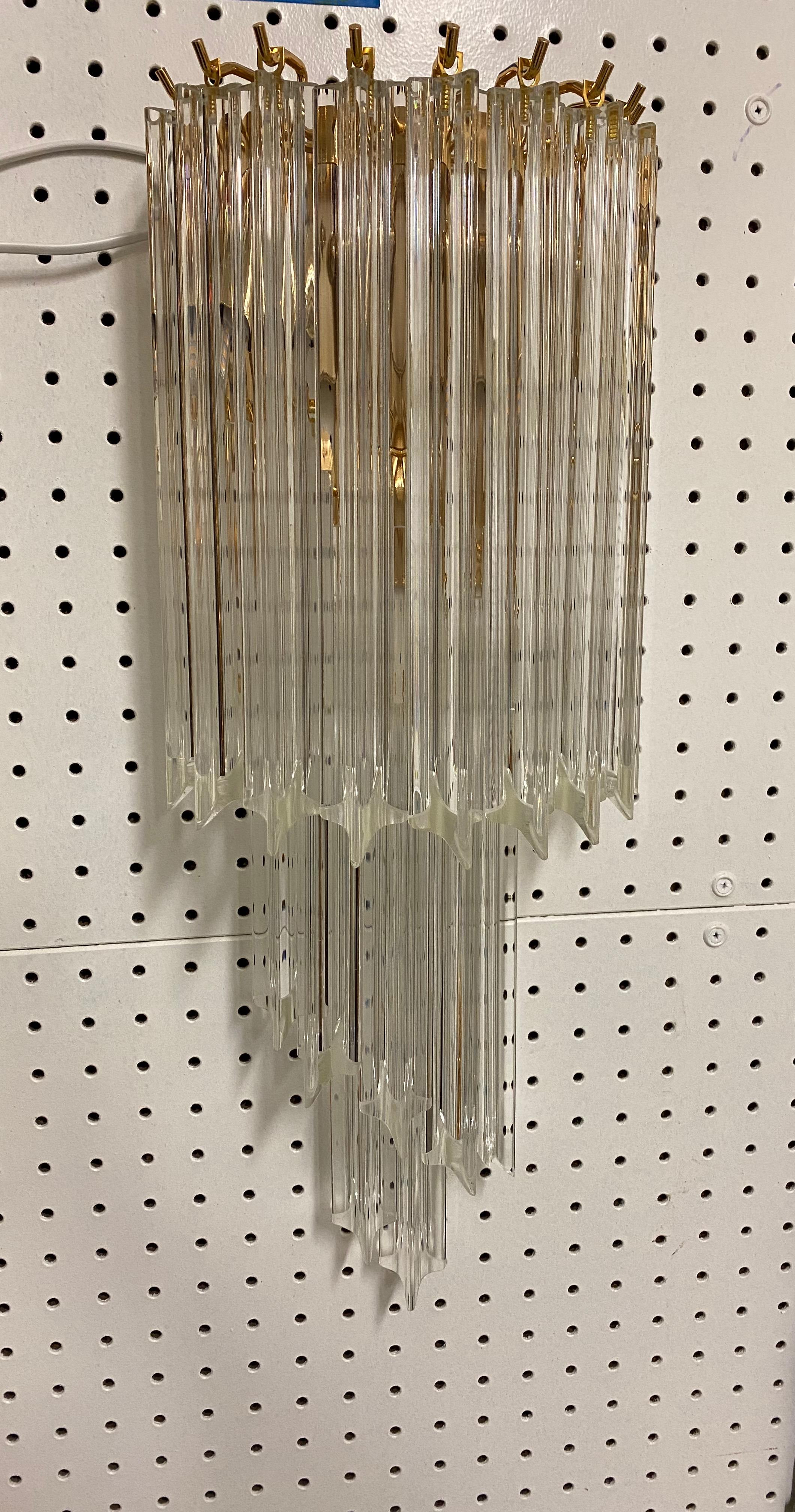 Mid century Pair of spiral Murano wall sconces. Each of the prisms are solid glass. They hang from hooks onto a brass frame, as pictured. Has been Rewired for American use with two candelabra sockets each. For a max watt of 120 watts in each sconce.