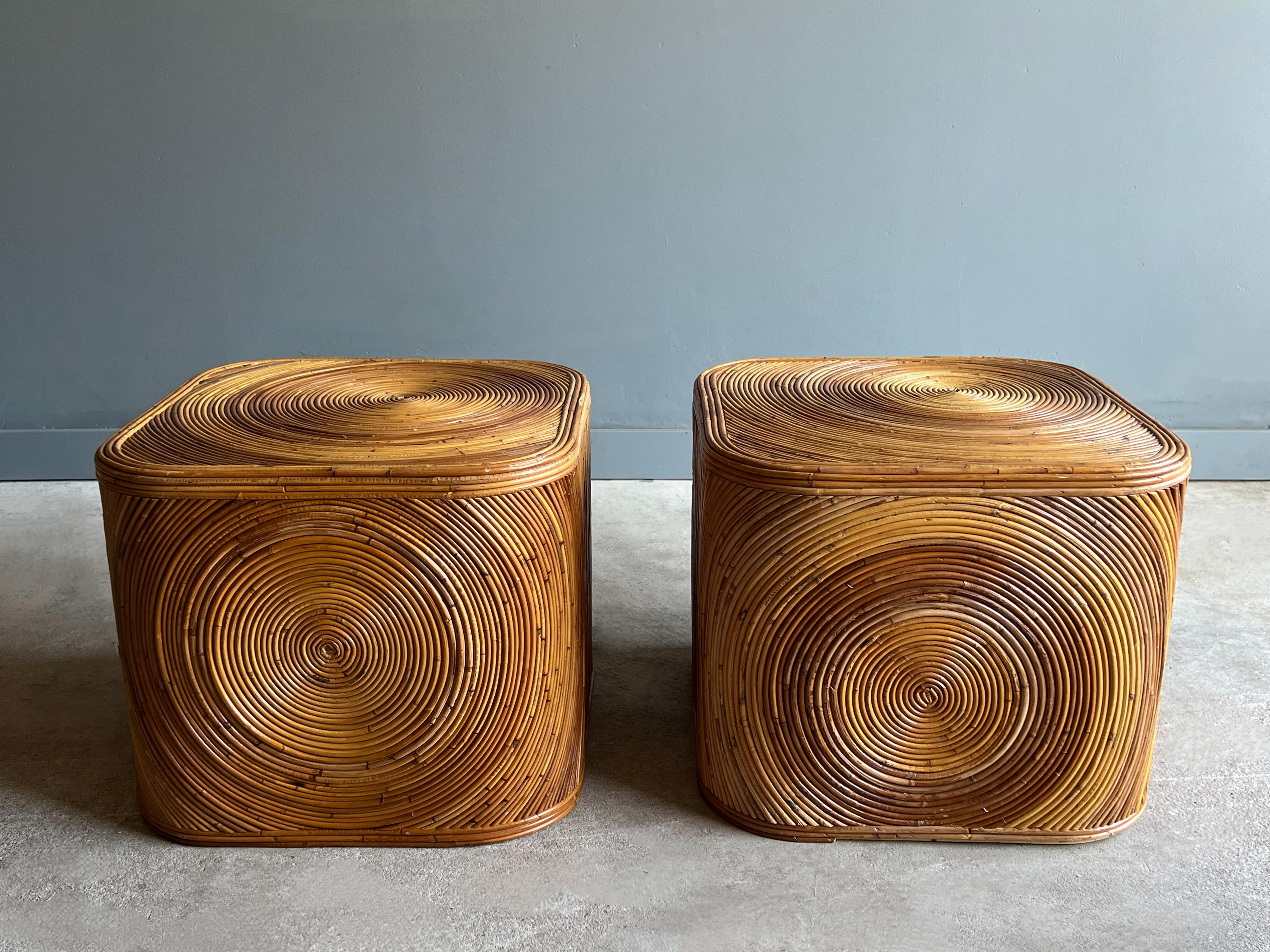 Amazing pair of vintage split reed bamboo tables. Each table features an organic spiral pattern on one side and top. They can be displayed facing any direction depending on desired pattern and movement. 

The bent split reeds vary in color and
